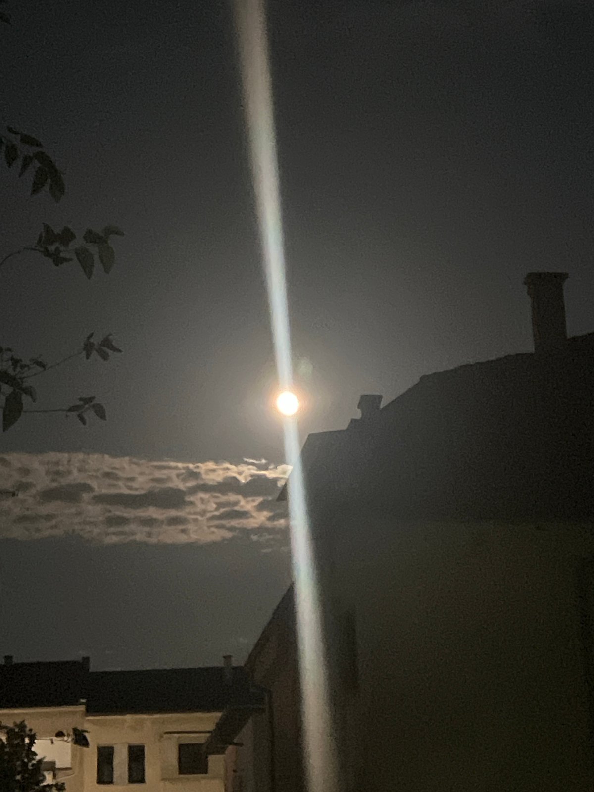Full moon and light beam over Blagoevgrad on a July night