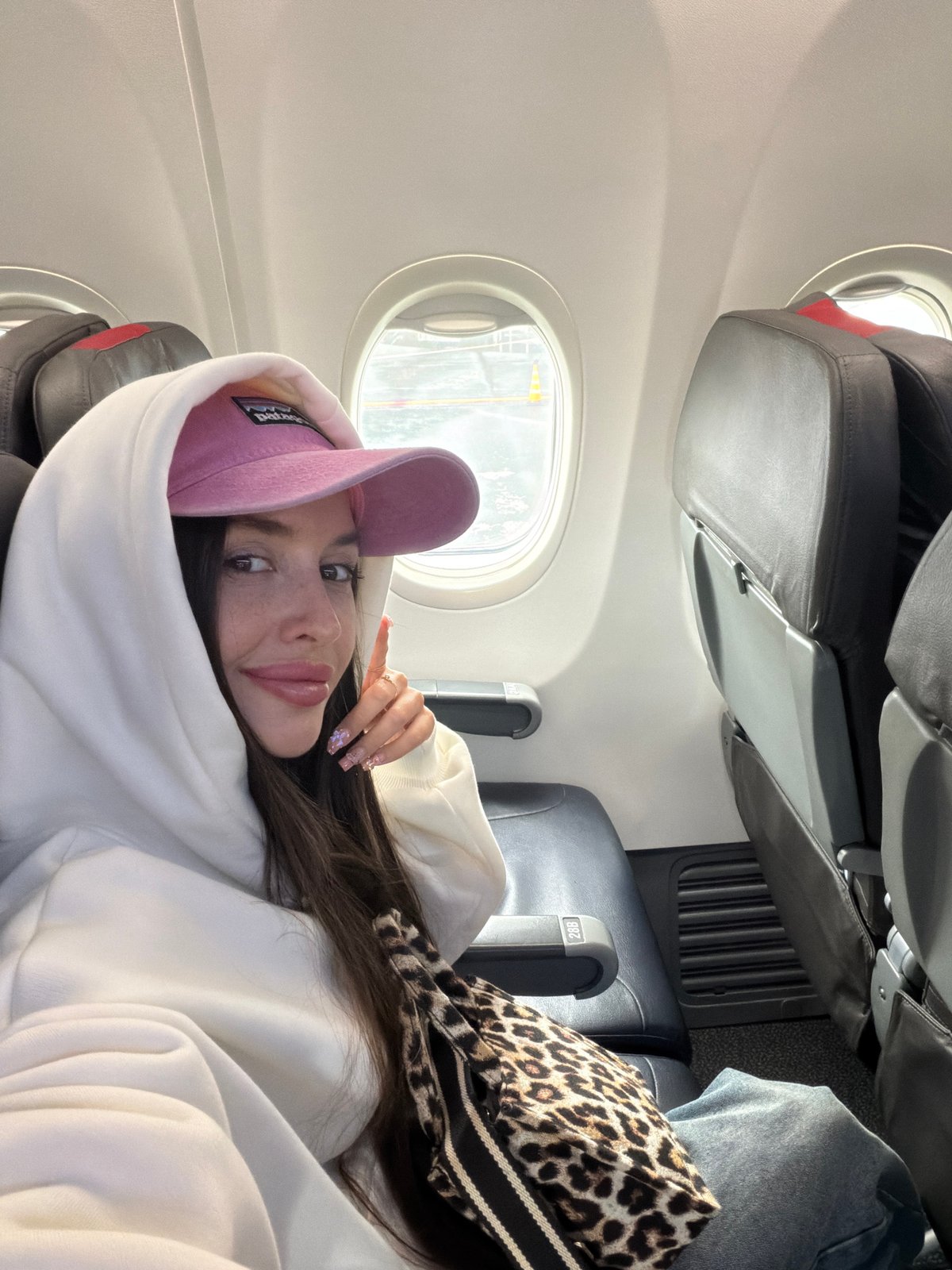 Passenger documents flight experience with cabin and tarmac photos