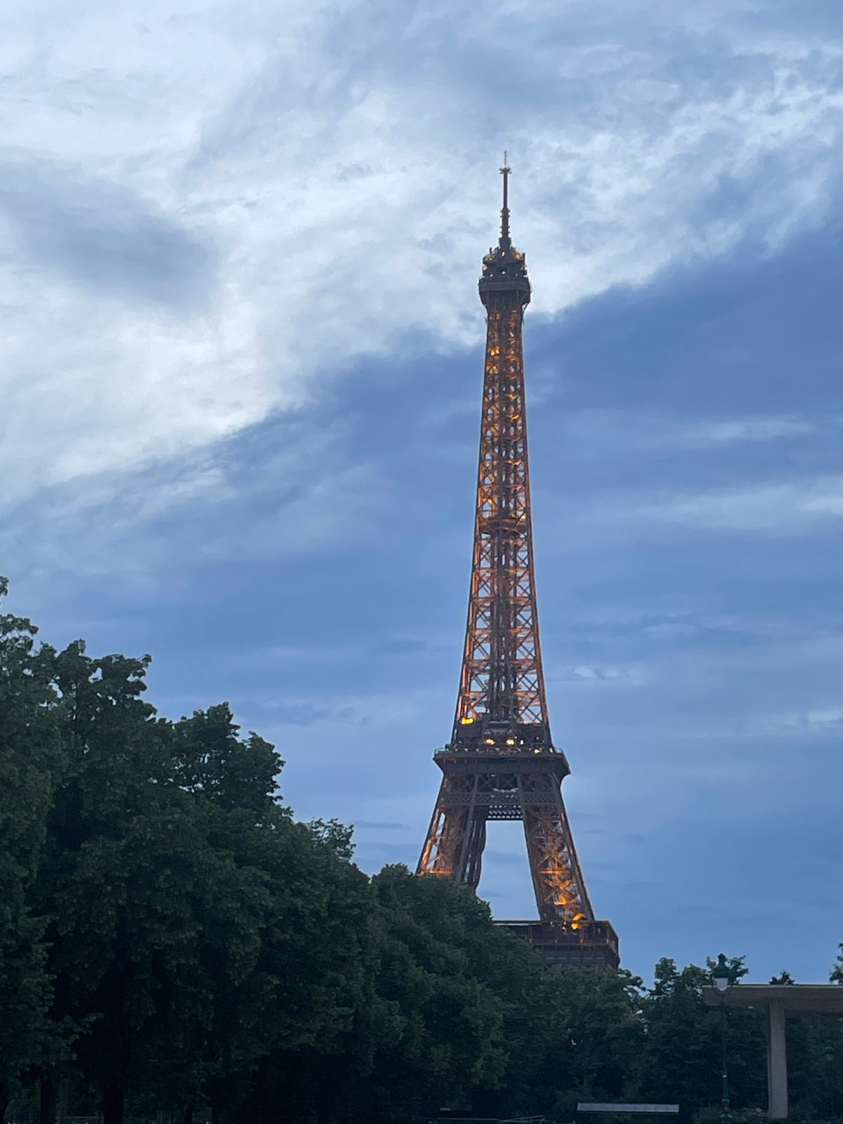 Eiffel Tower glows golden during evening illumination display