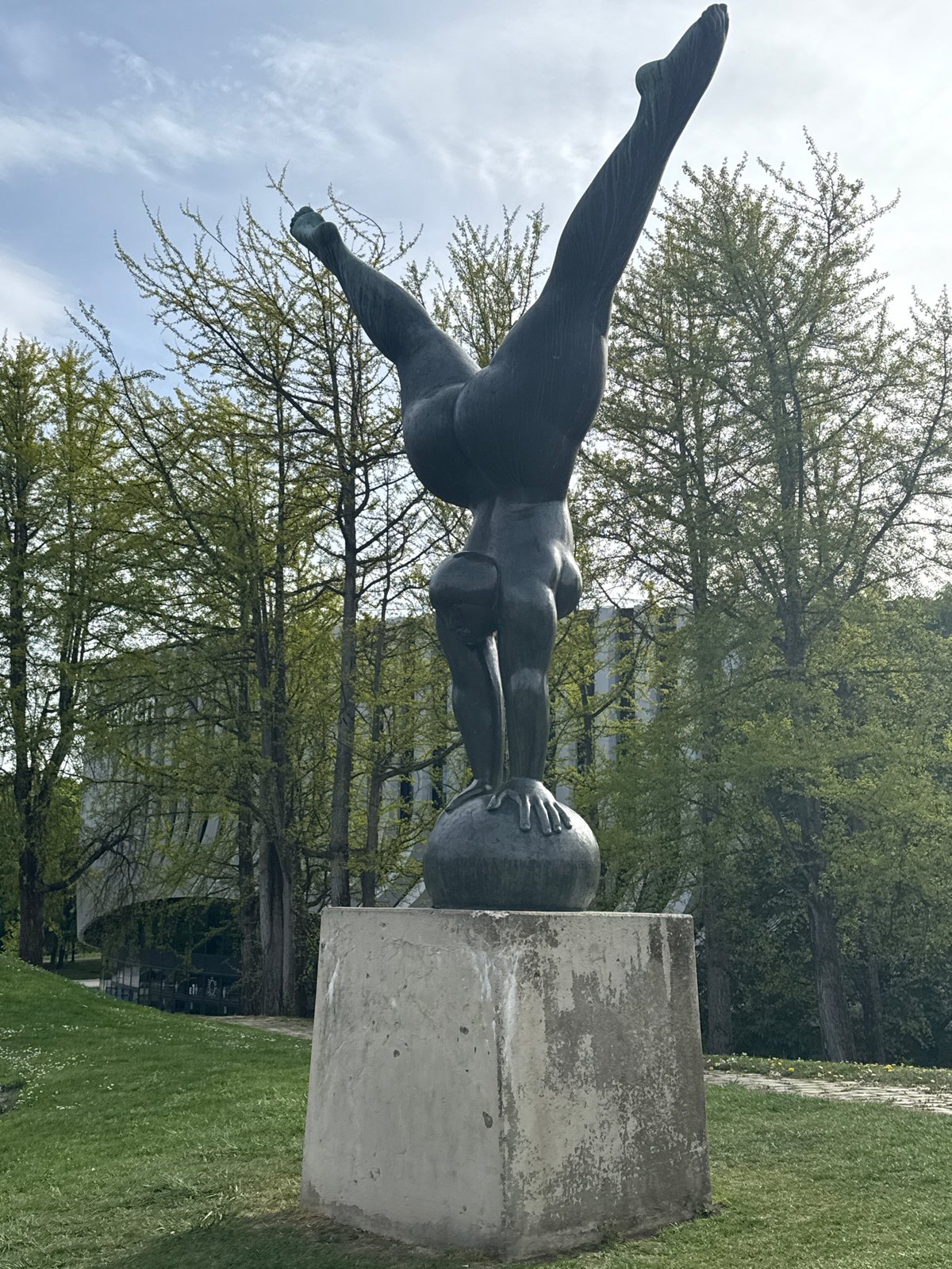 Bronze statue and modern building photographed in Munich