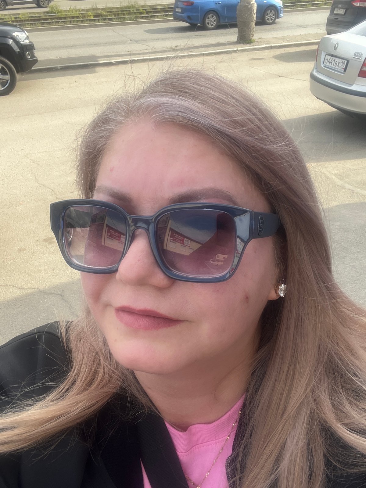 Woman takes selfies in sunny Izhevsk during afternoon