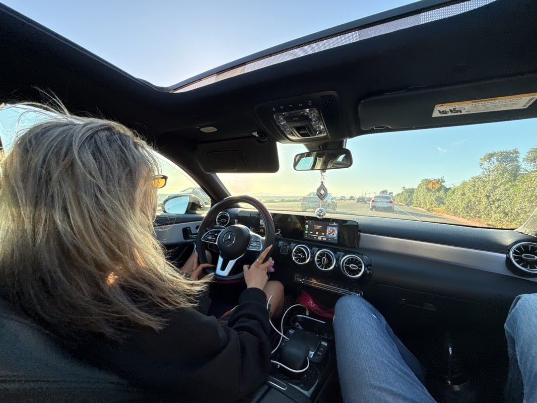 Woman drives Mercedes with open sunroof on Huntington Beach highway