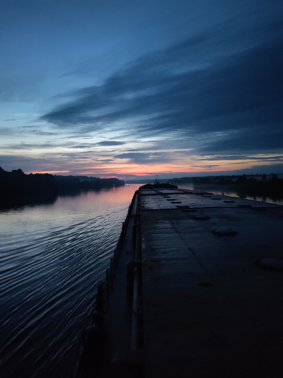 Barge on a still river at twilight, Uzhla, Russia