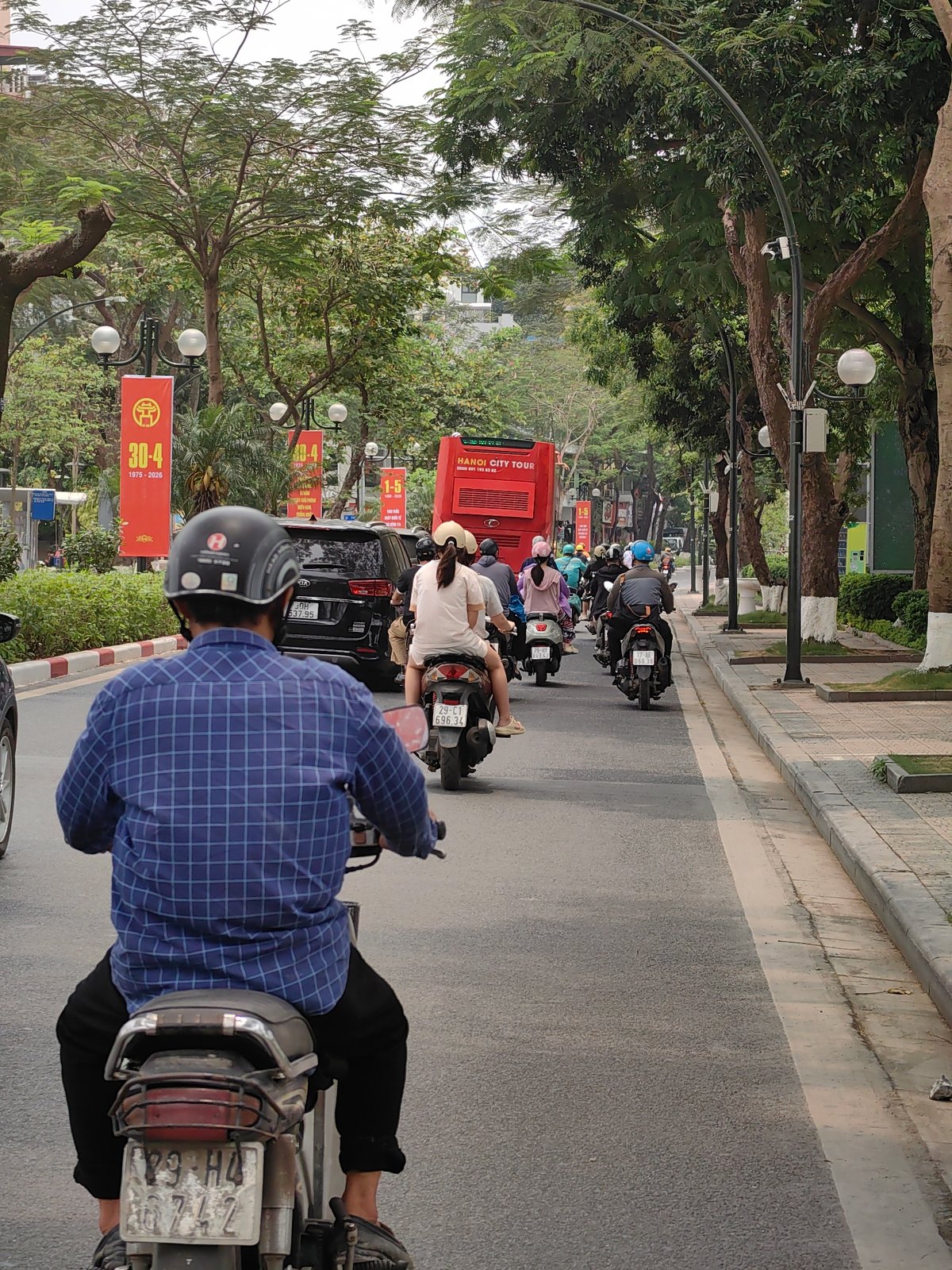Morning motorbike traffic flows through Hanoi streets