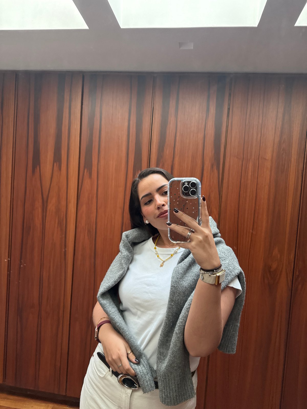 Woman poses for photos with laptop on marble stairs
