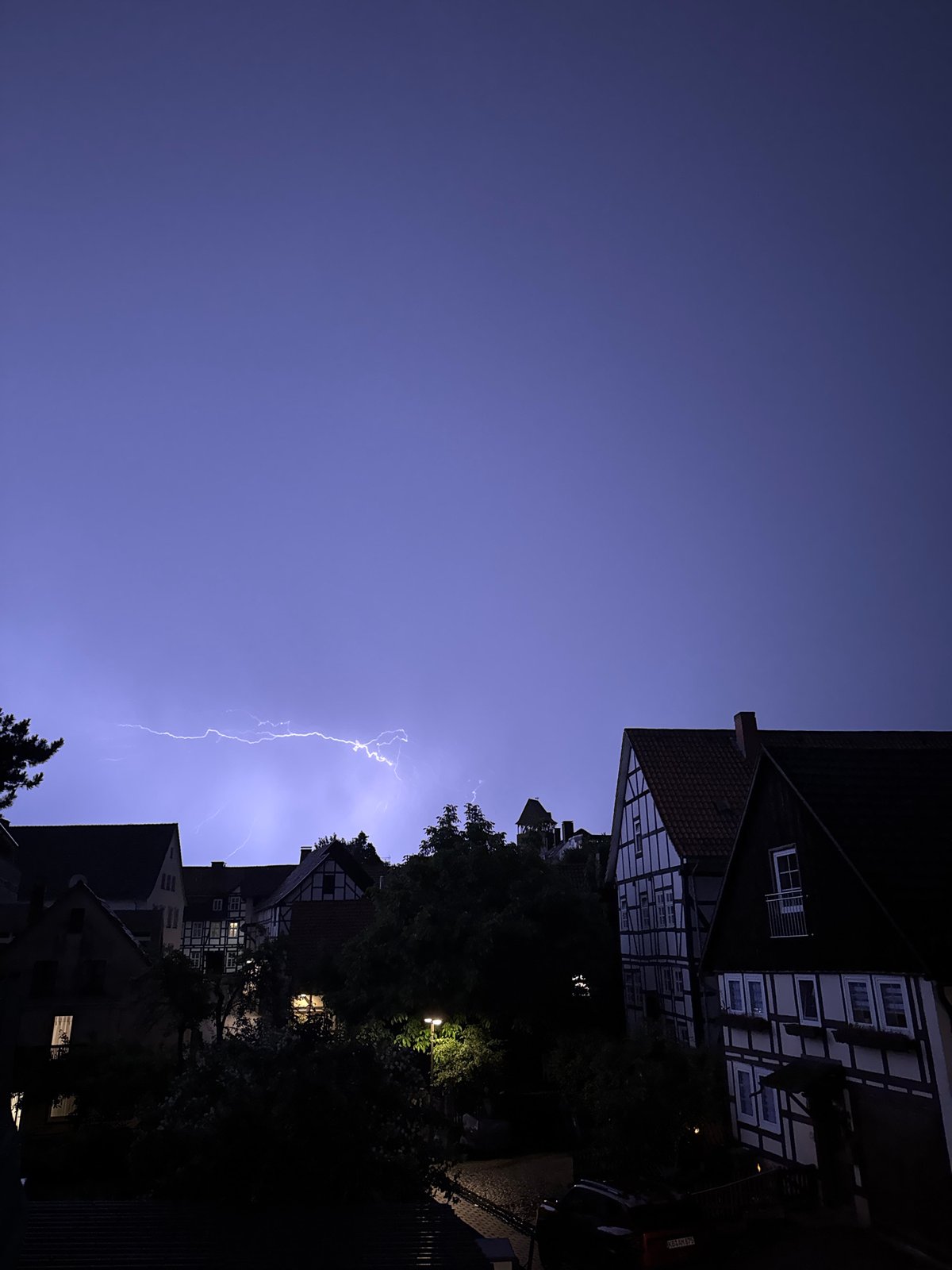 Thunderstorm lights up a German town on a summer night