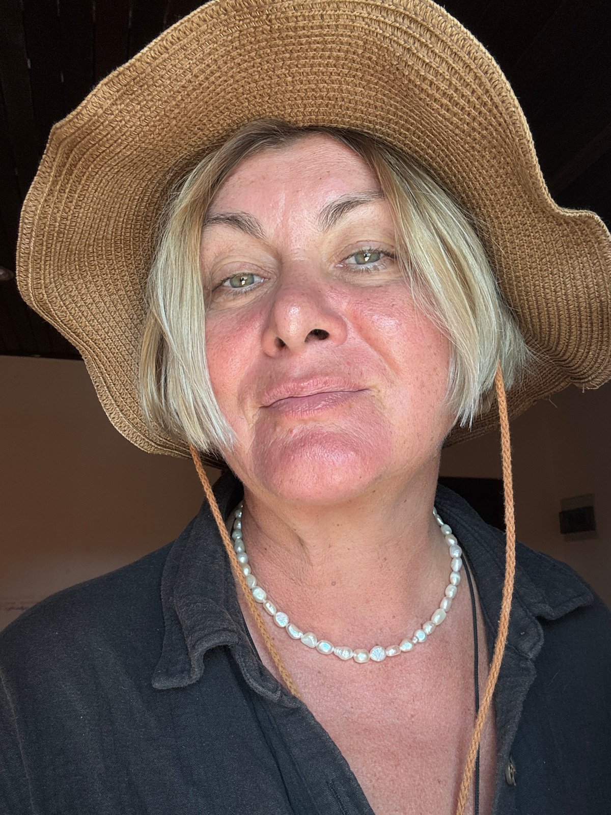 Blonde woman in pearls documented in Thai residential setting