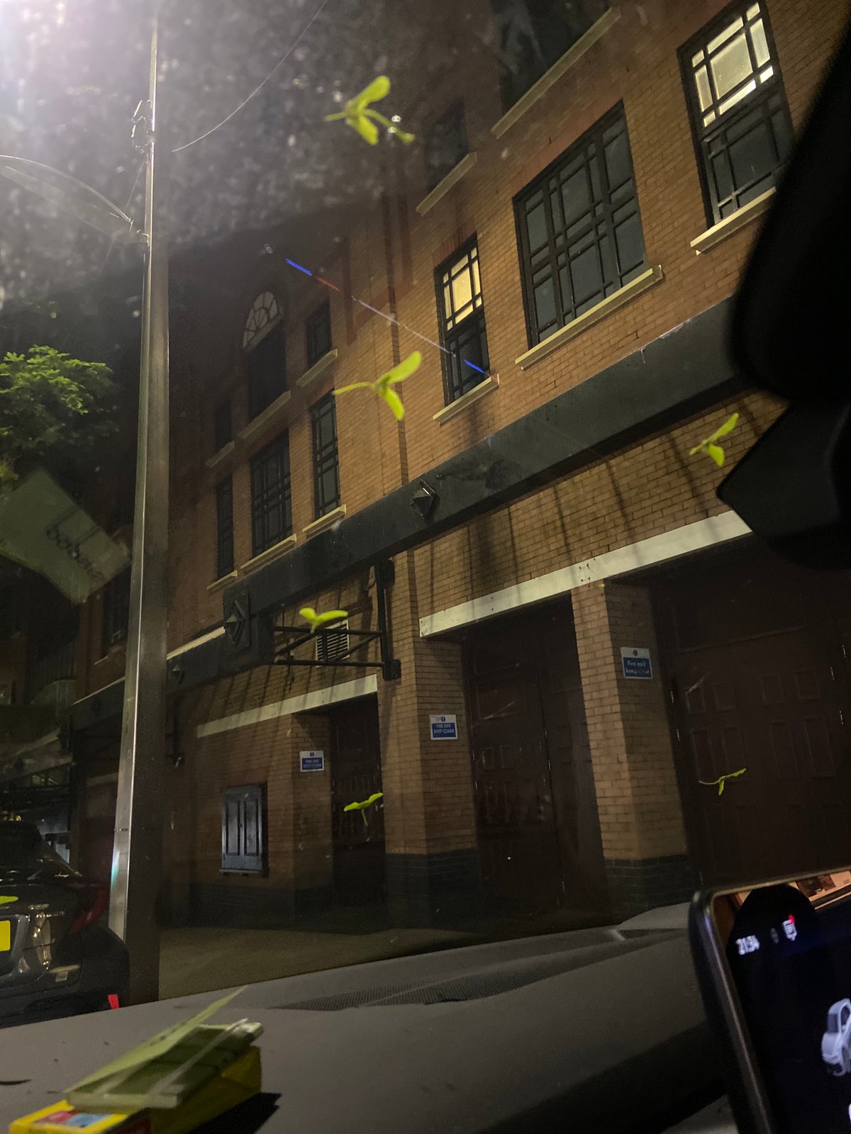 Nighttime photo of brick building captured from vehicle in Bristol