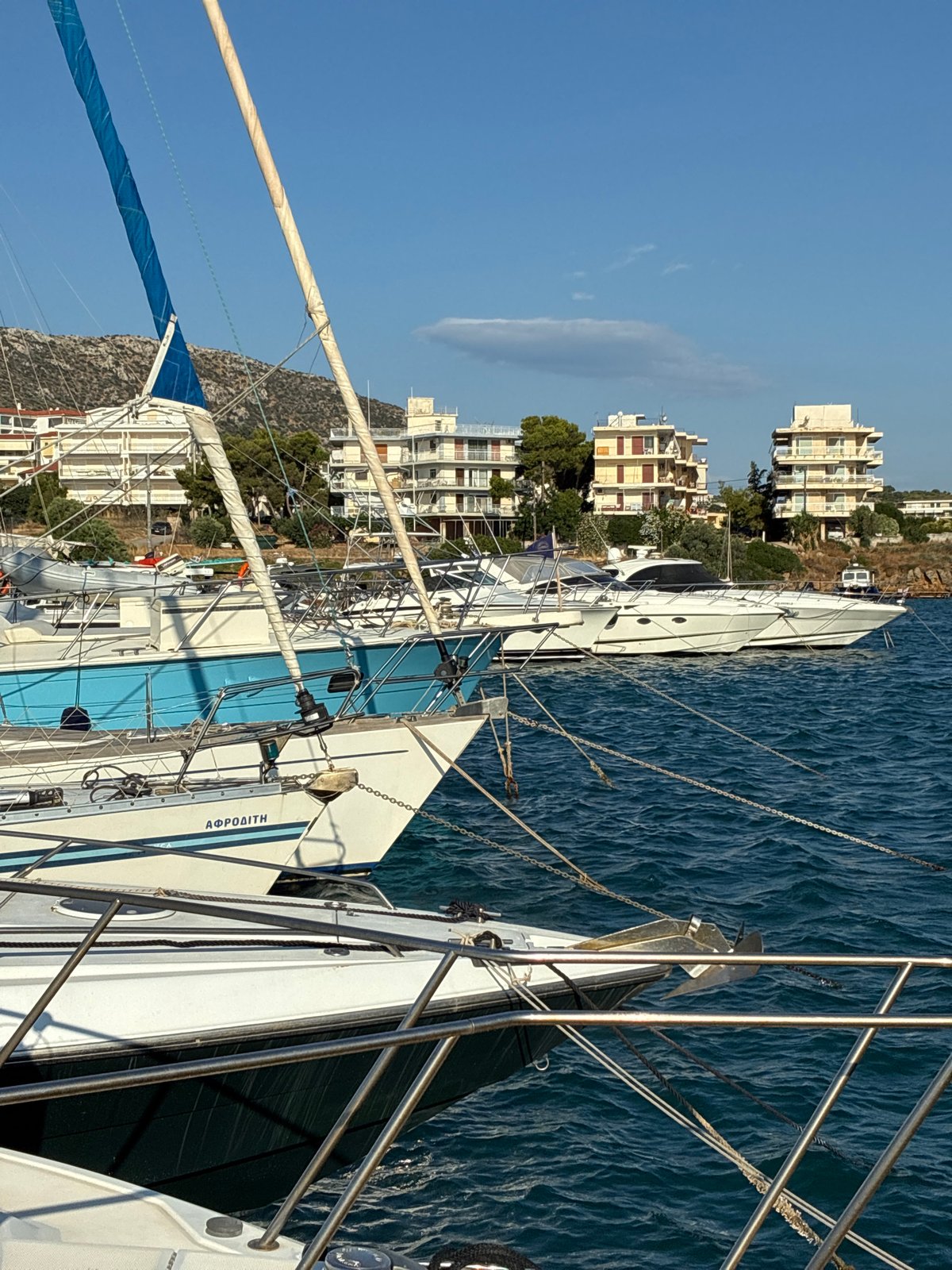 Quiet morning at Limenas Markopoulou harbor, boats moored in calm water