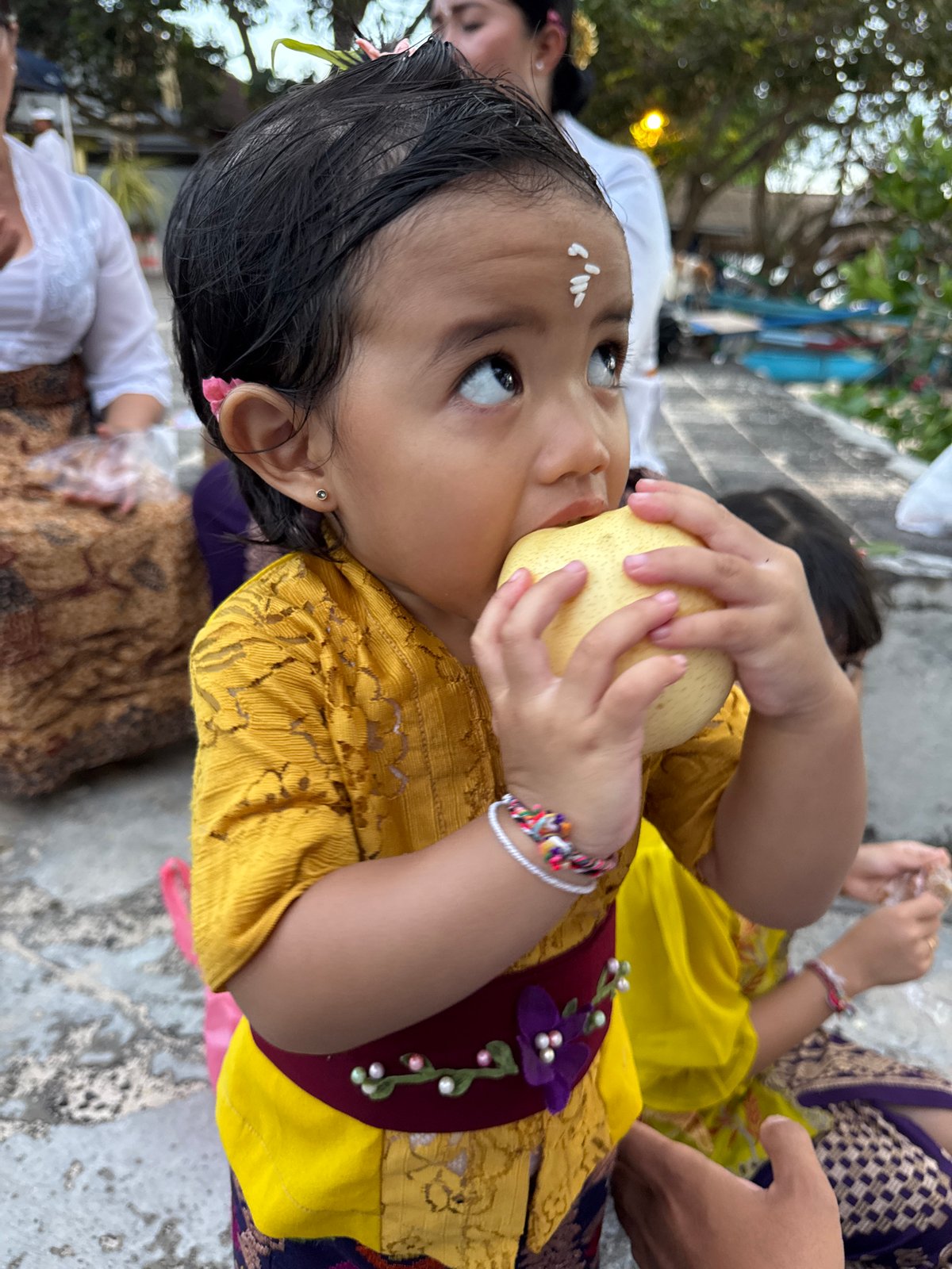 Traditional Balinese ceremony with child and gamelan musicians in Kuta