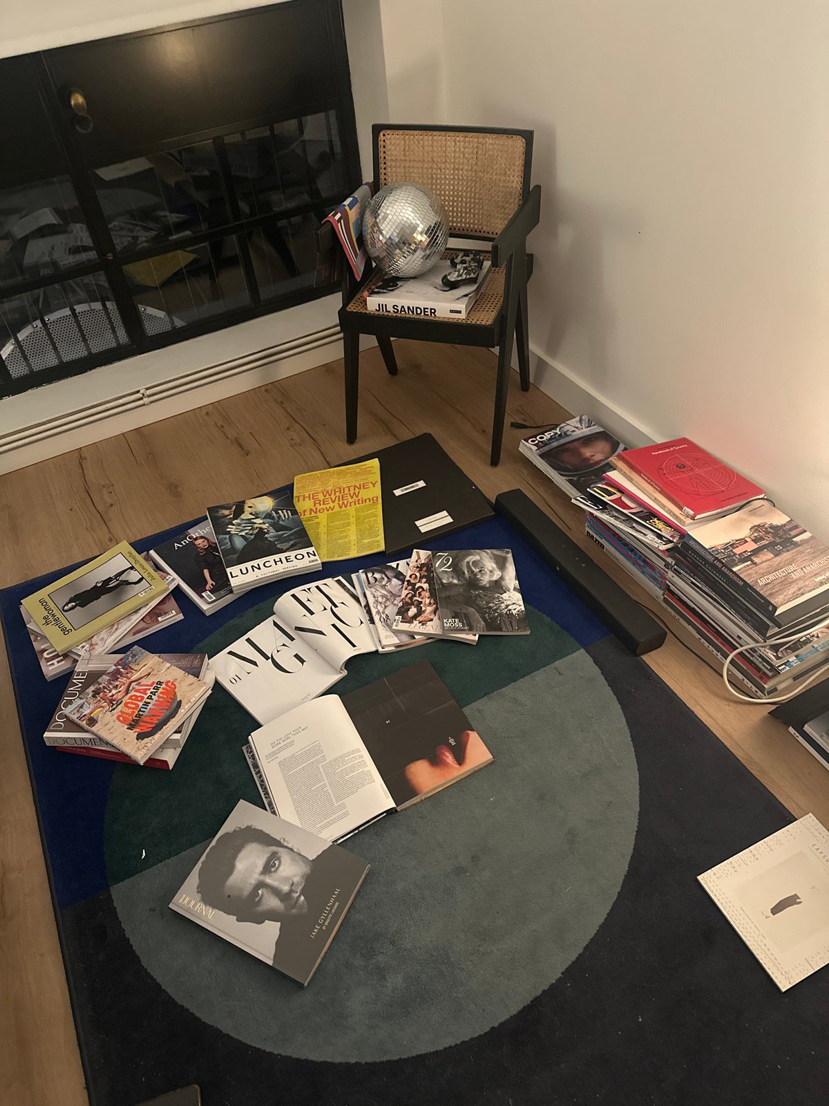 London resident enjoys evening reading session with art magazines, tea