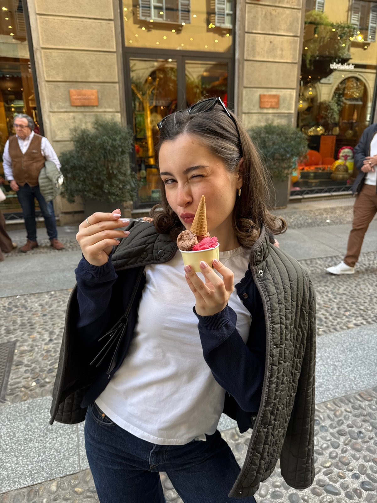 Woman photographed outside chocolate shop in Milan street scene