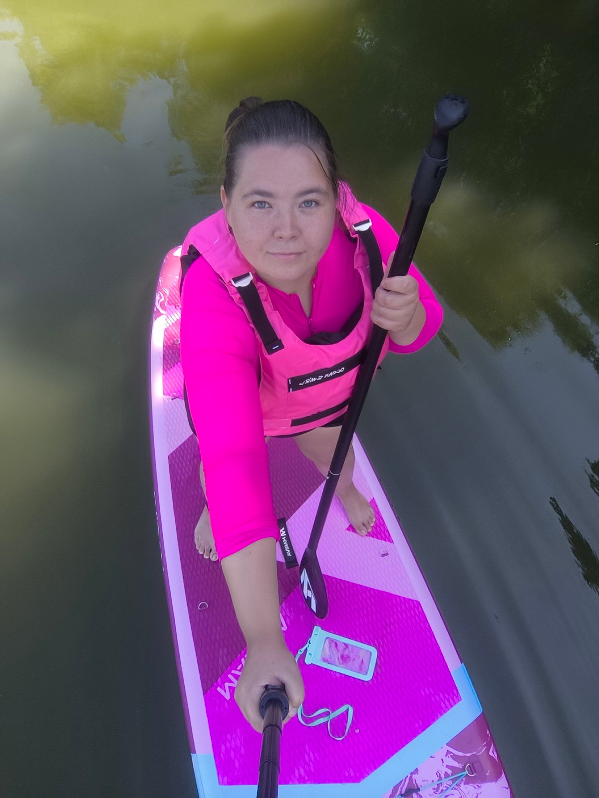 Pink paddleboard session on calm Kaliningrad waters