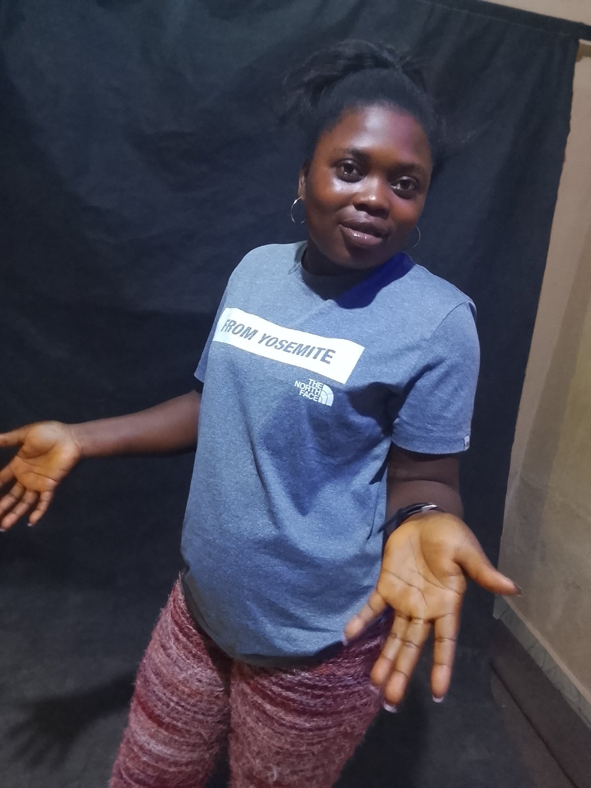Woman poses for photos in North Face shirt