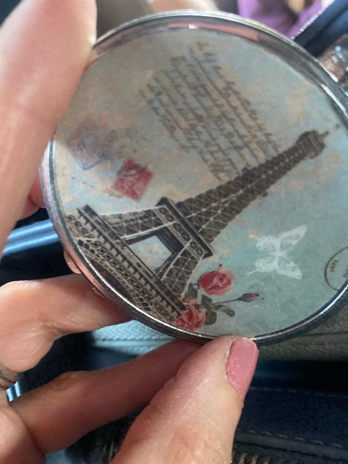 Person holds Eiffel Tower-designed compact mirror in Mexico City