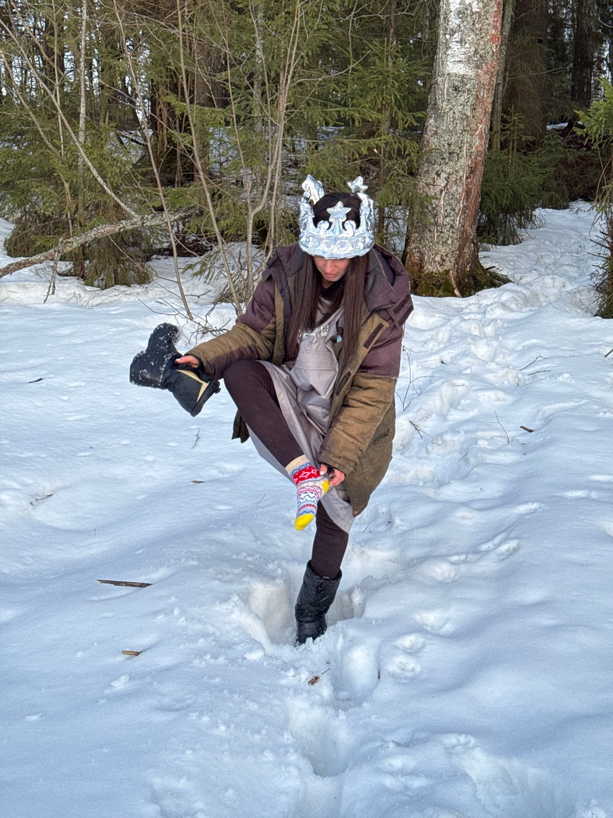 Woman plays with decorated eggs in snowy Russian village