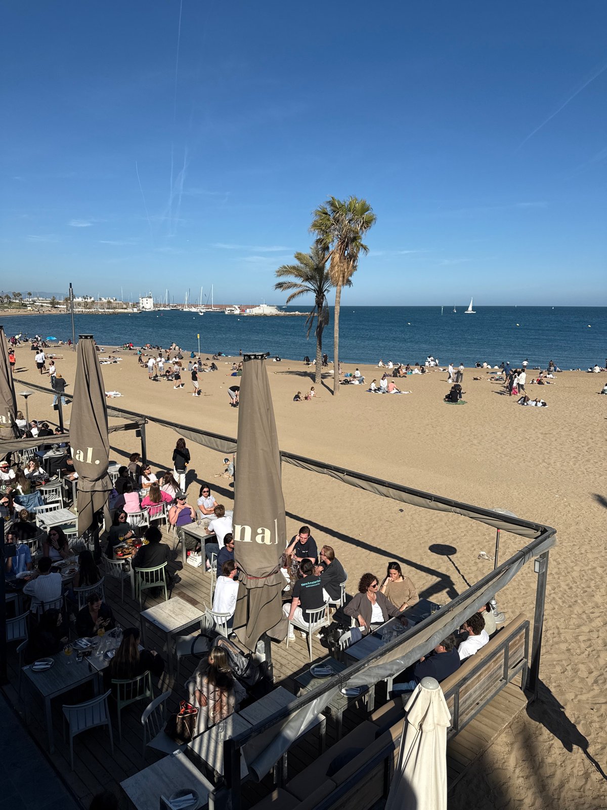 Busy afternoon beach scene captured in Barcelona, Spain