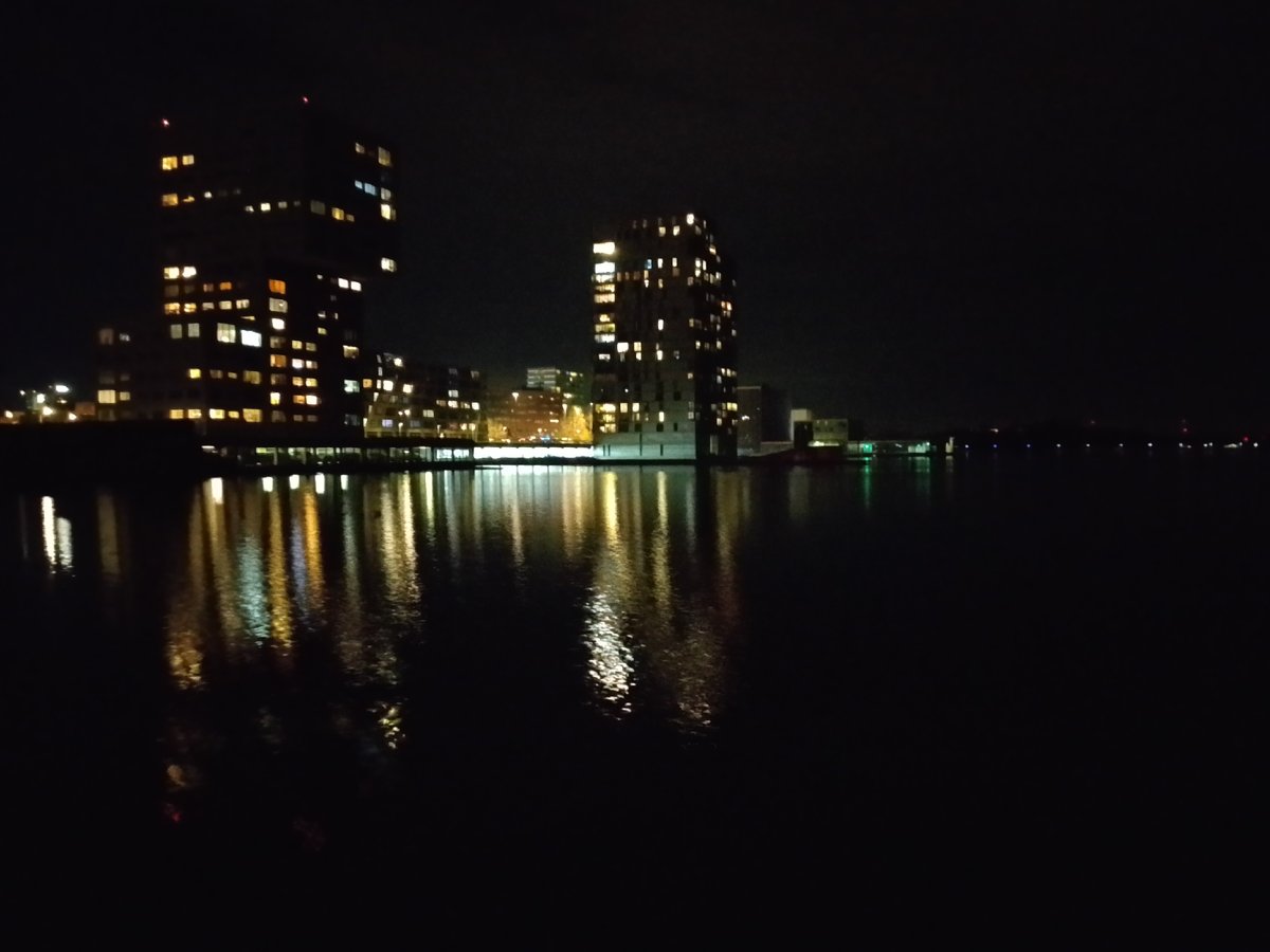 Nighttime building reflections captured in Almere waterway