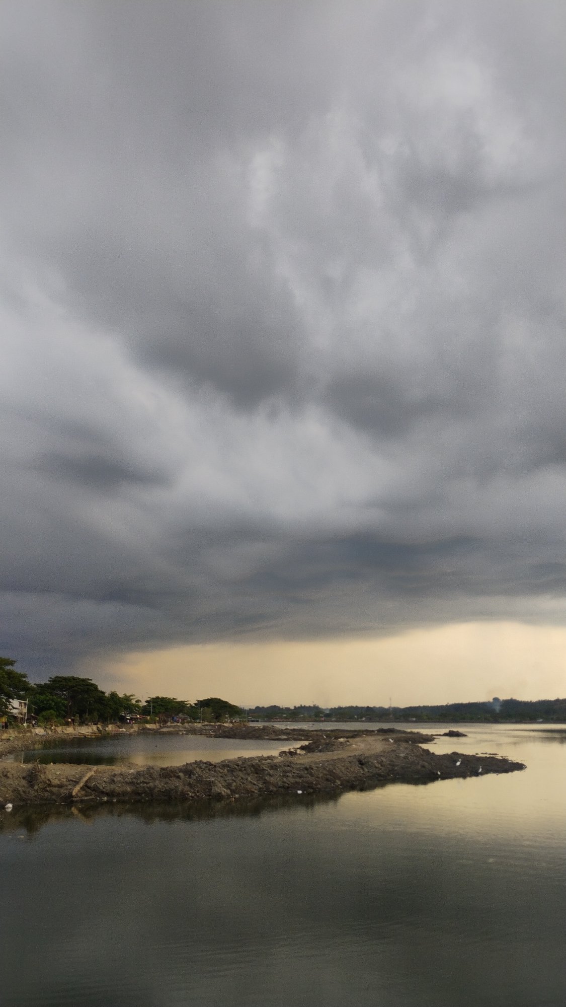 Stormy skies over Lhokseumawe's waterfront and estuary