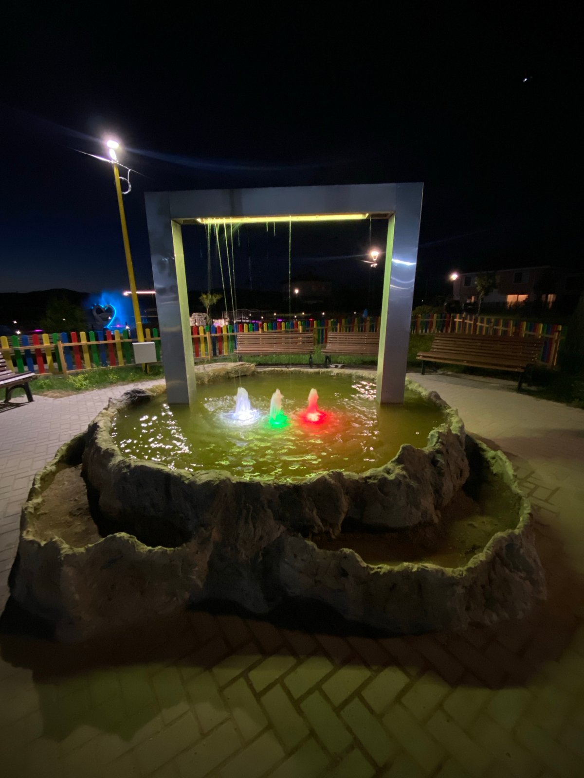 Colorful fountain lights up a park in Elin Pelin at night