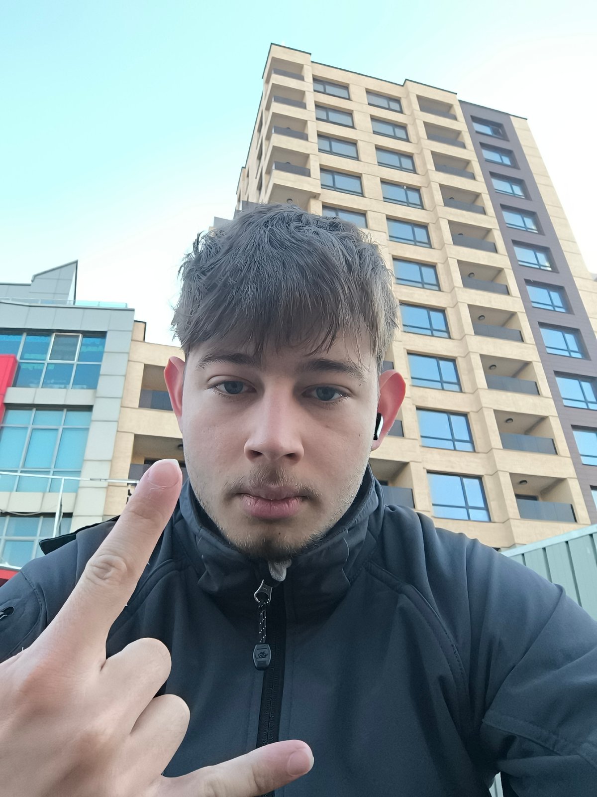 Young man photographed taking selfies in Sofia early morning