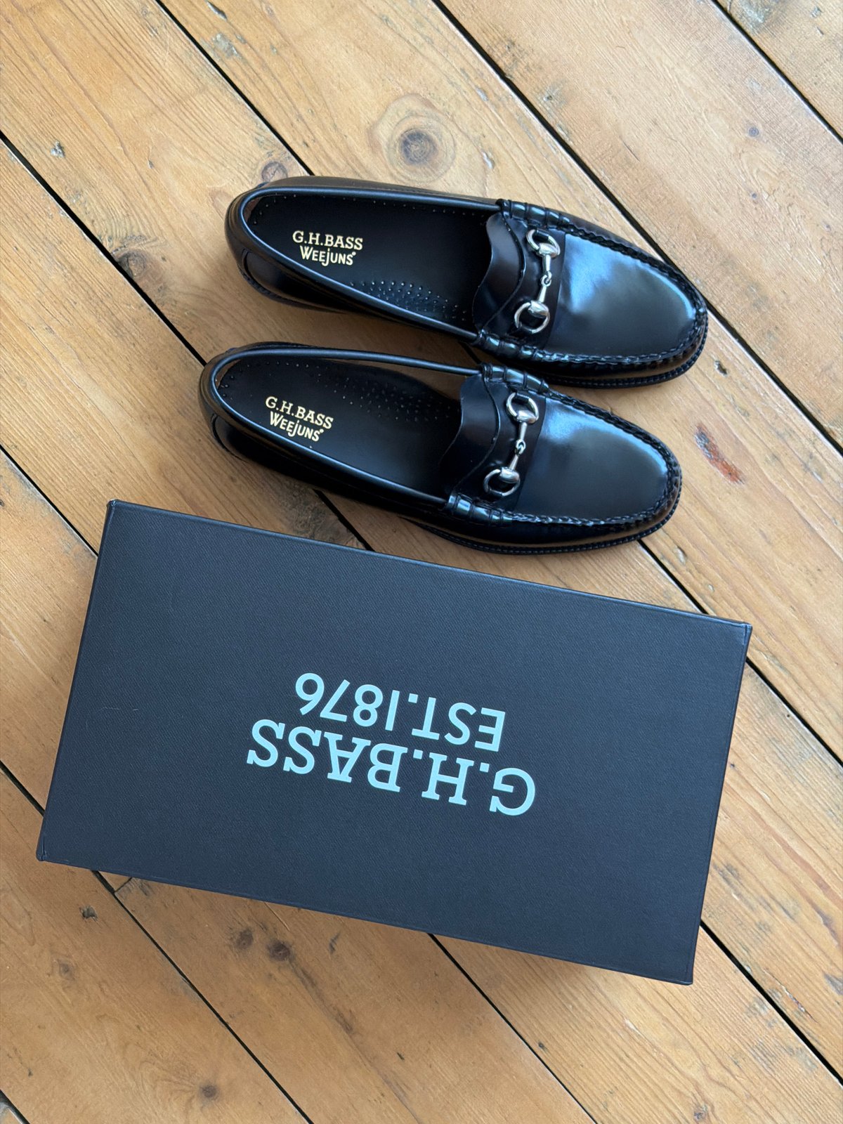 Black loafers photographed with shoe box in UK home