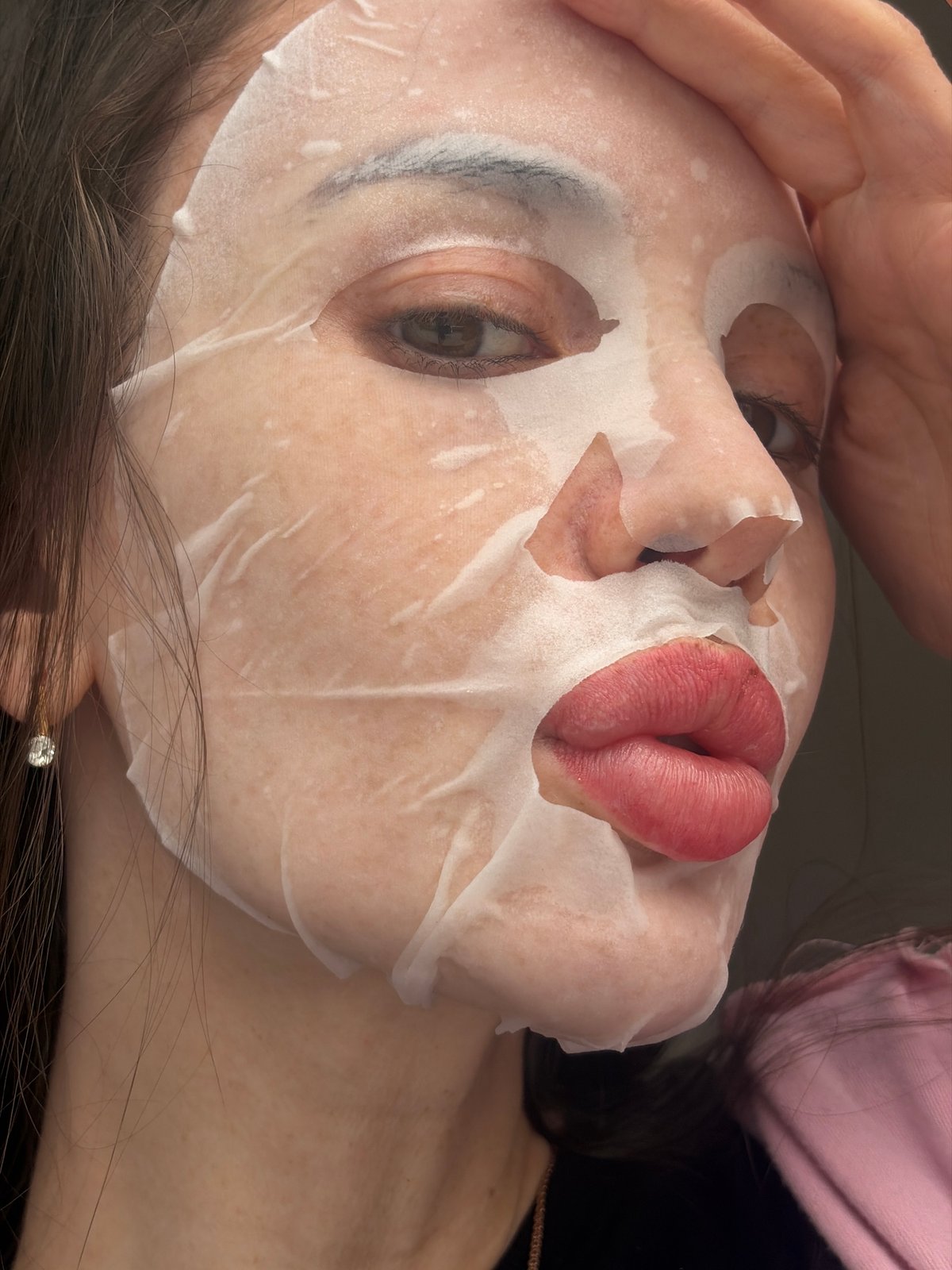 Person documents skincare routine with facial mask in Saint Petersburg