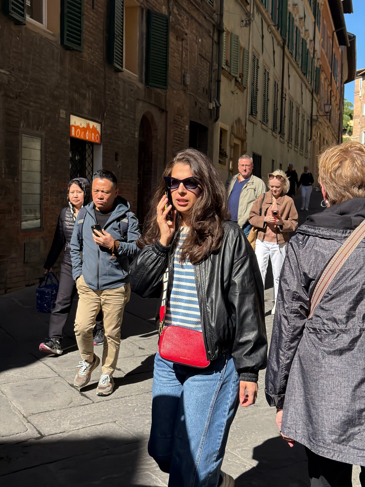 Morning tourist activity captured in historic Siena streets