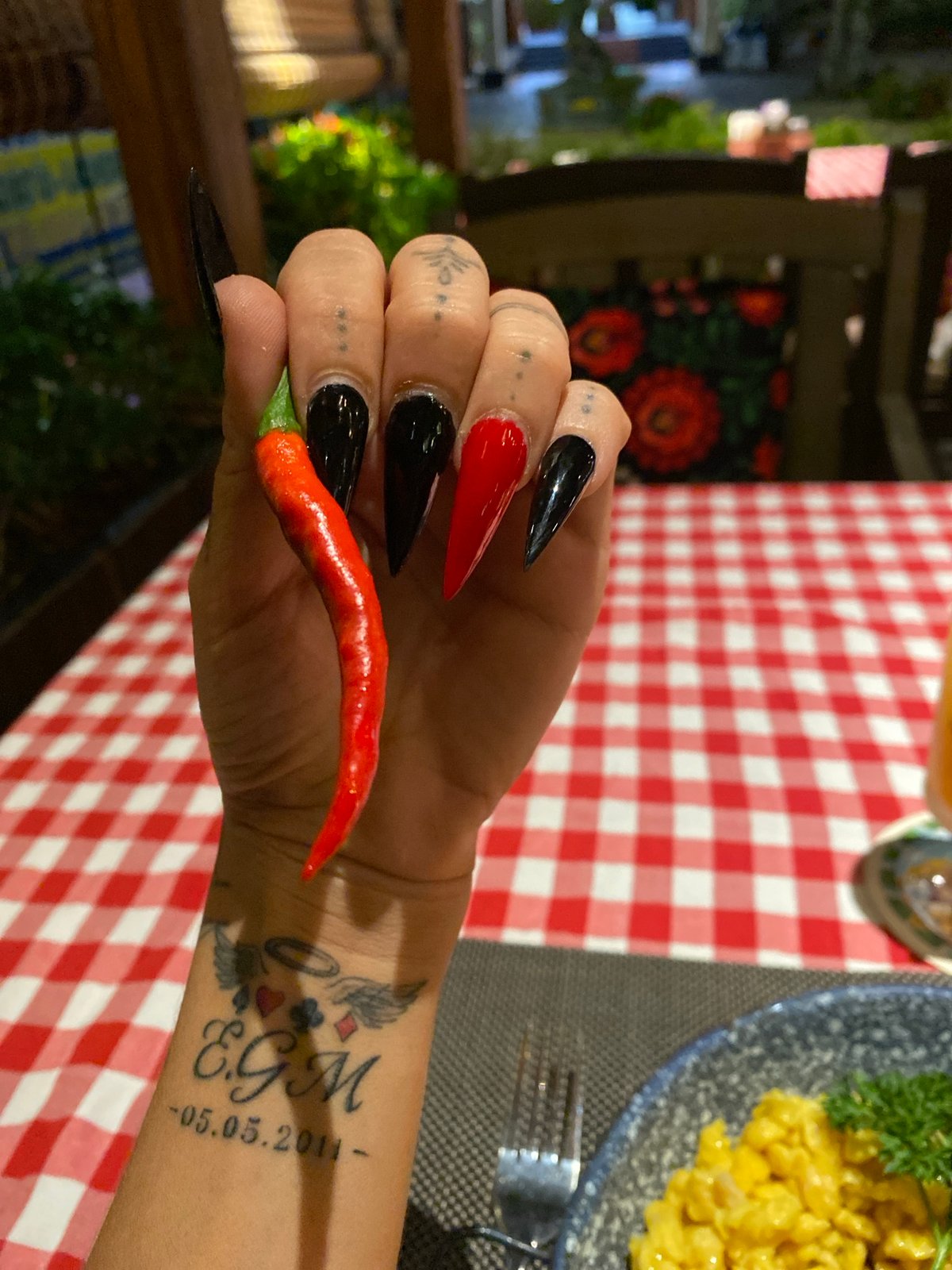 Tattooed diner enjoys meal with chili pepper in Vietnam