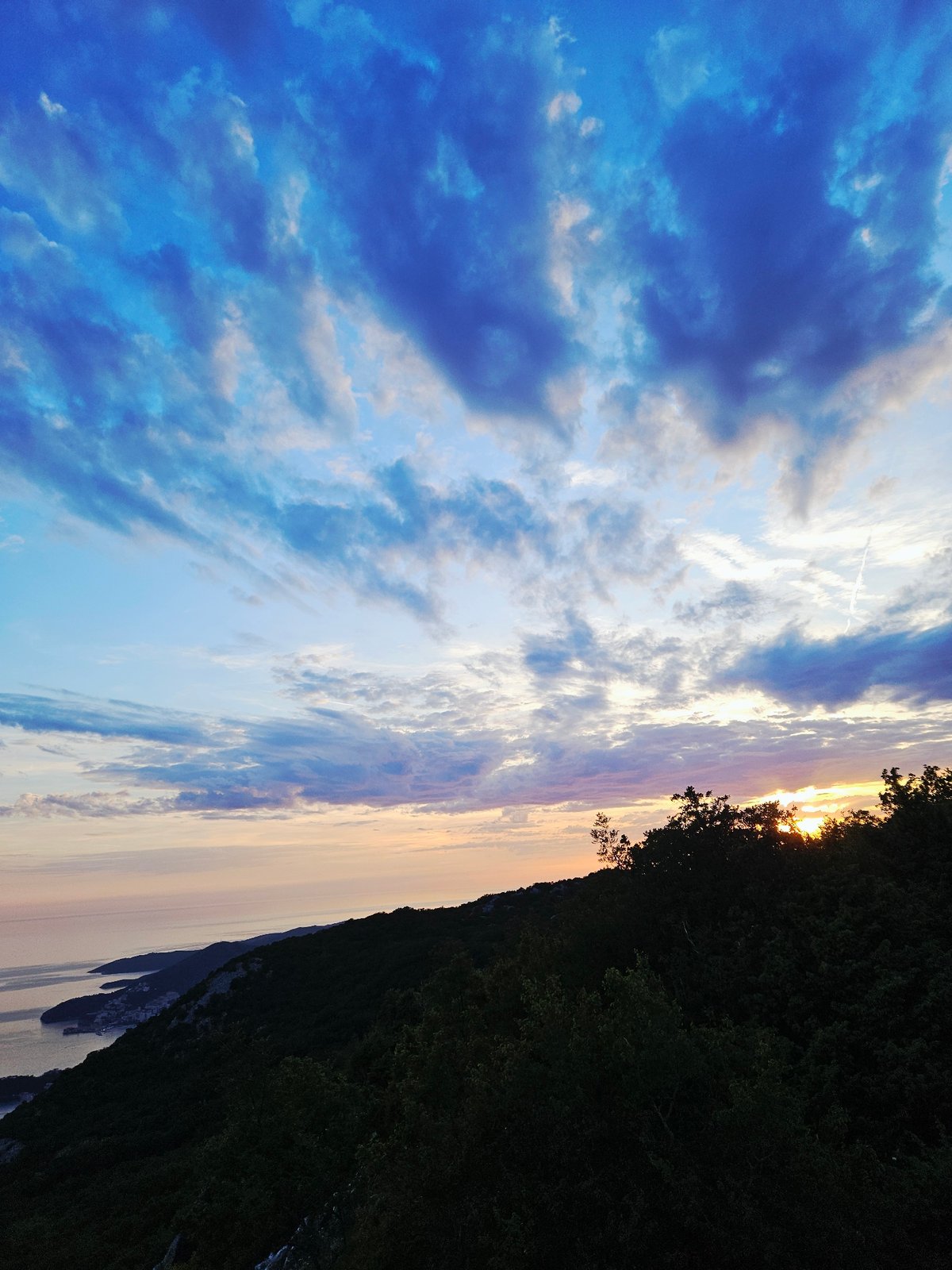 Sunset gathering at coastal overlook features tea, coffee, photography