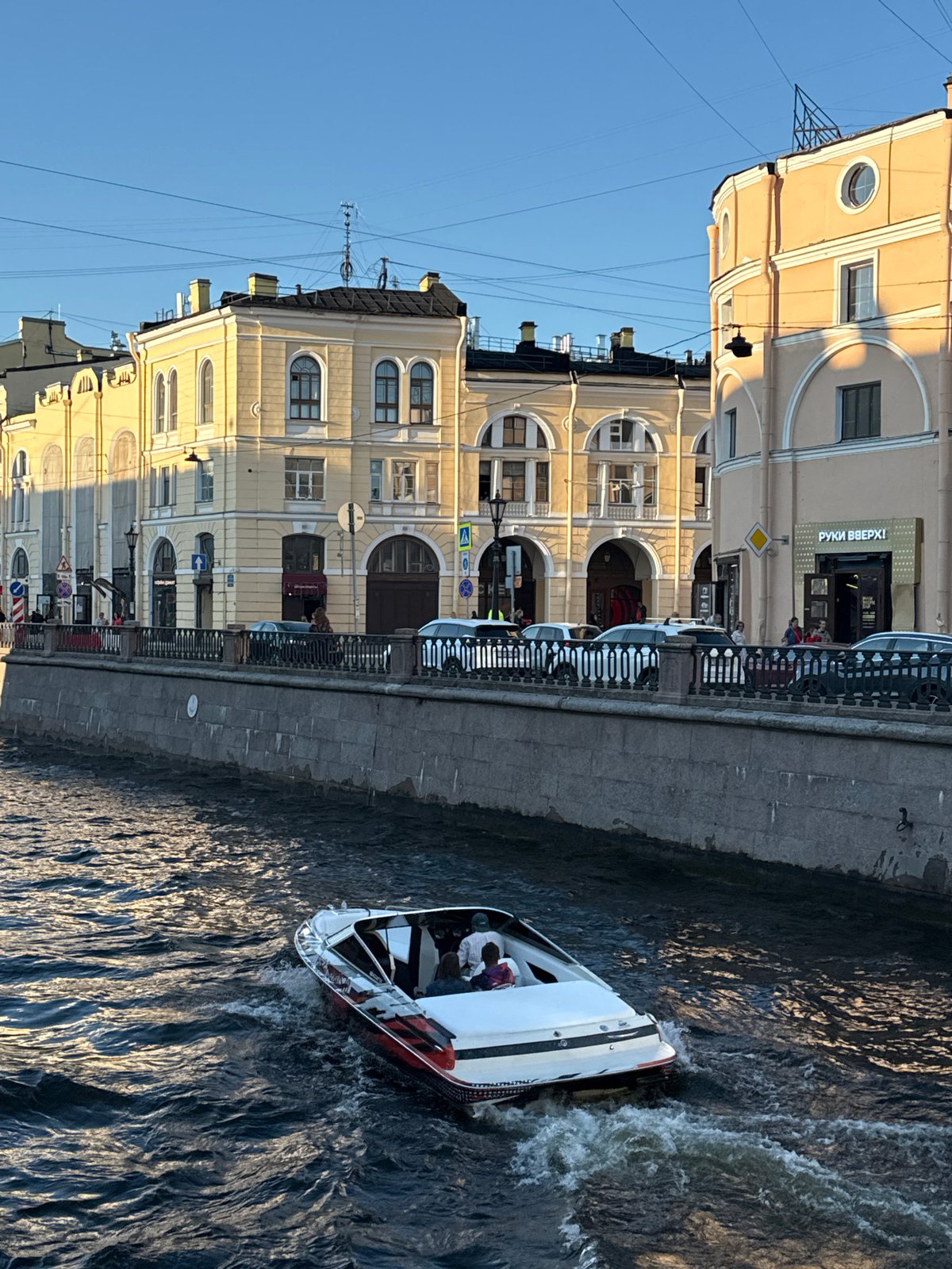 Evening life unfolds along Saint Petersburg's historic canals