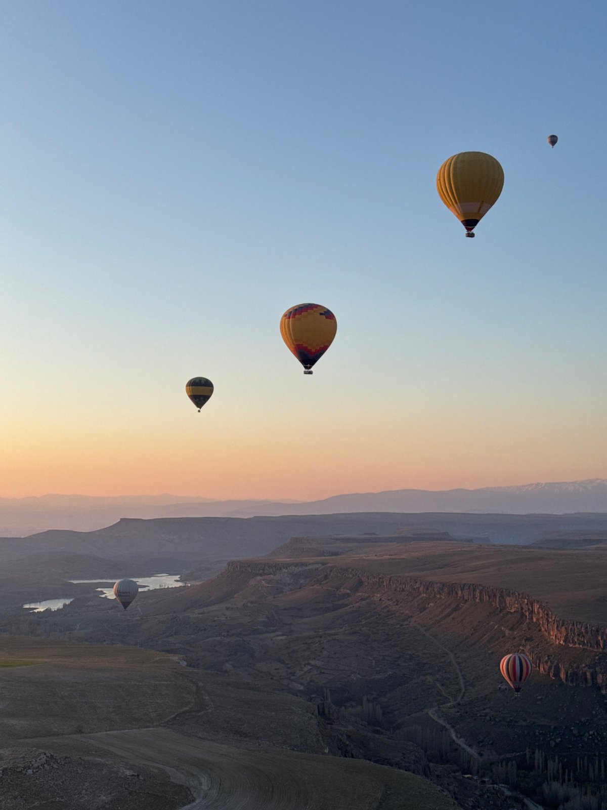 Hot air balloons soar over Yeşilhisar at sunrise
