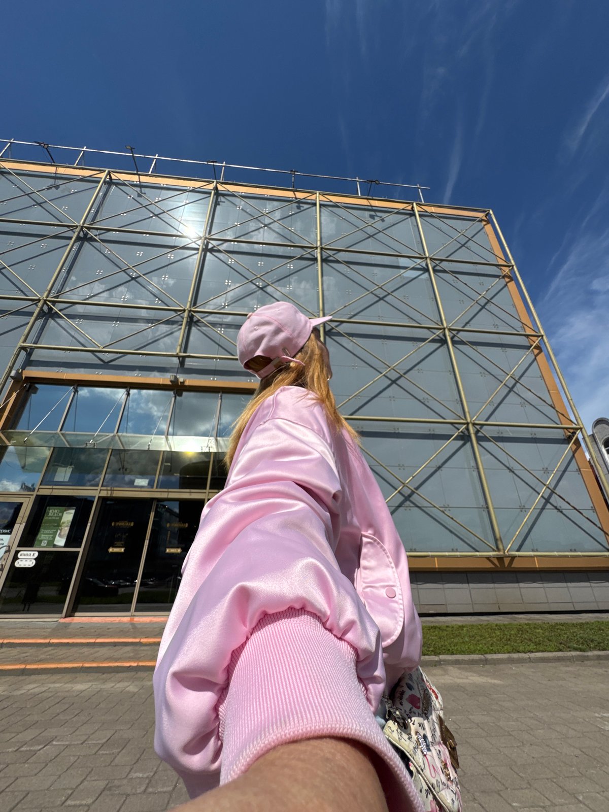 Pink jacket, selfies, and a ship-shaped building in Saint Petersburg