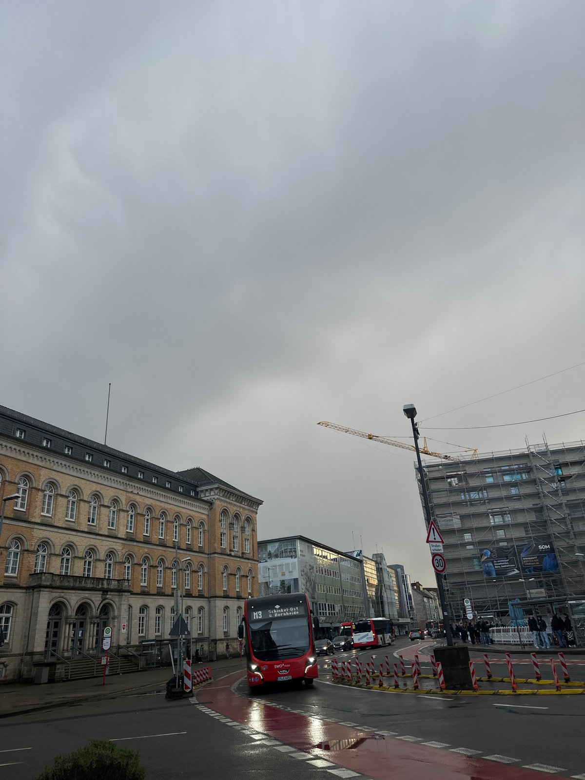 Double-decker bus navigates Osnabrück intersection during afternoon service