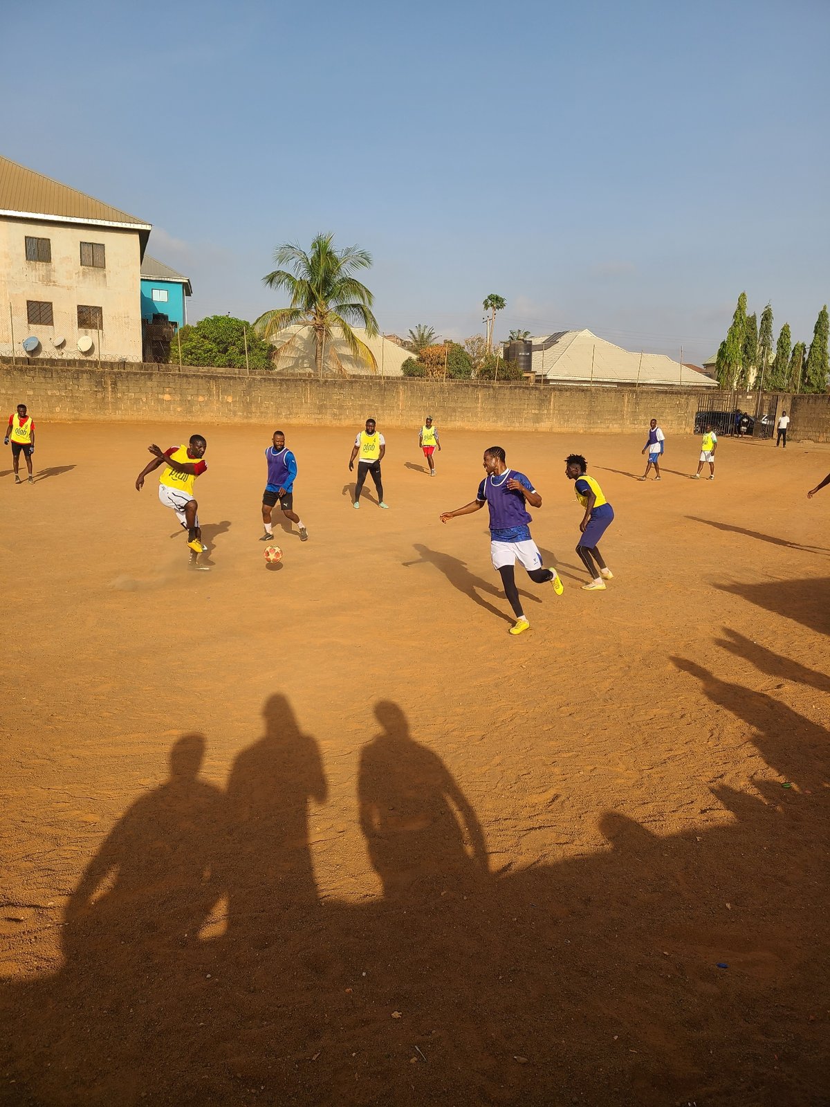 Morning soccer match on dirt field in Nigeria