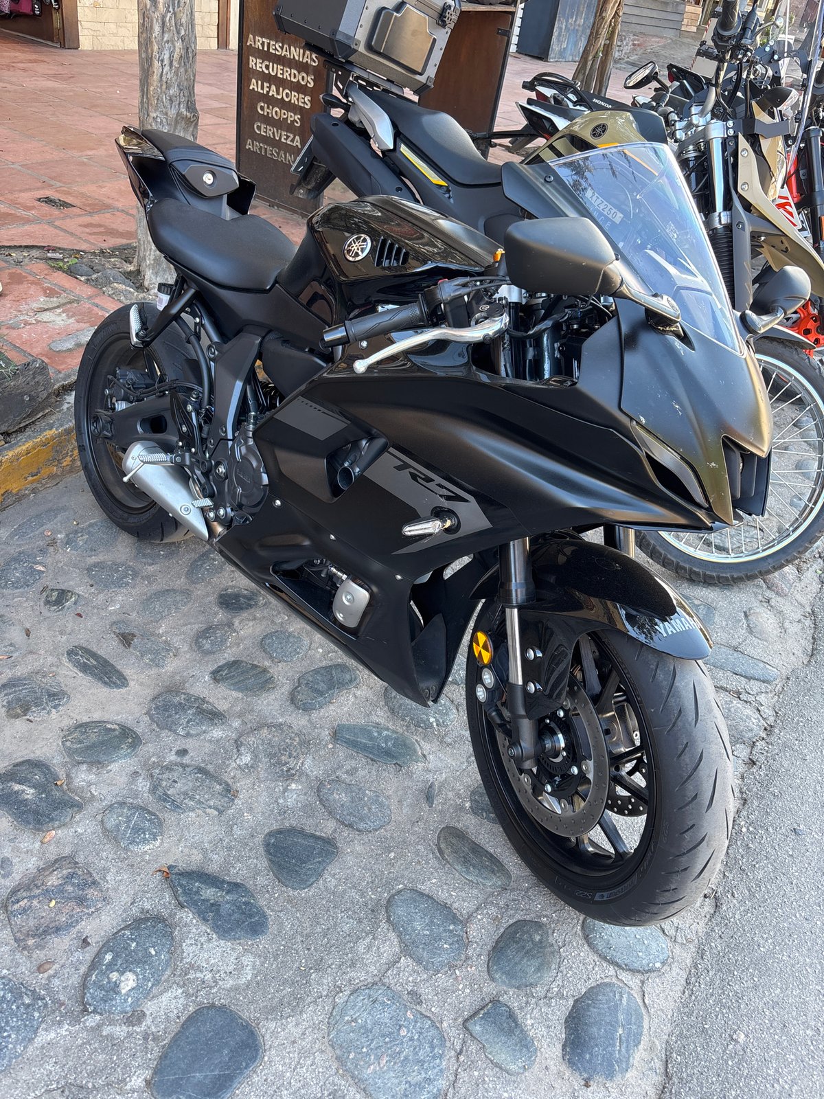 Black Yamaha R7 motorcycle spotted on cobblestones in Argentina