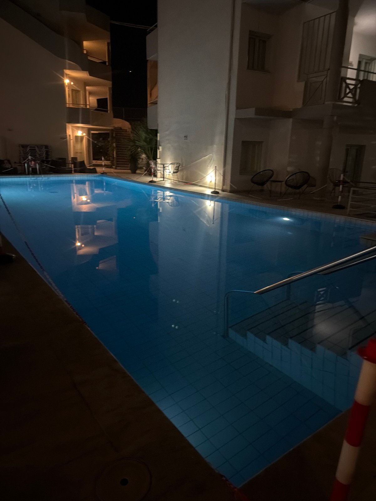 Lit outdoor pool at a Georgioupoli complex after dark