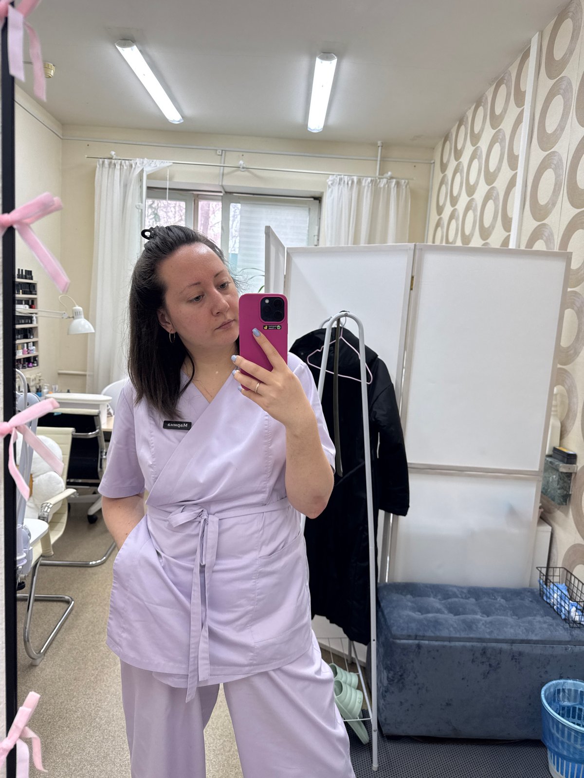 Healthcare worker takes mirror selfie in professional setting