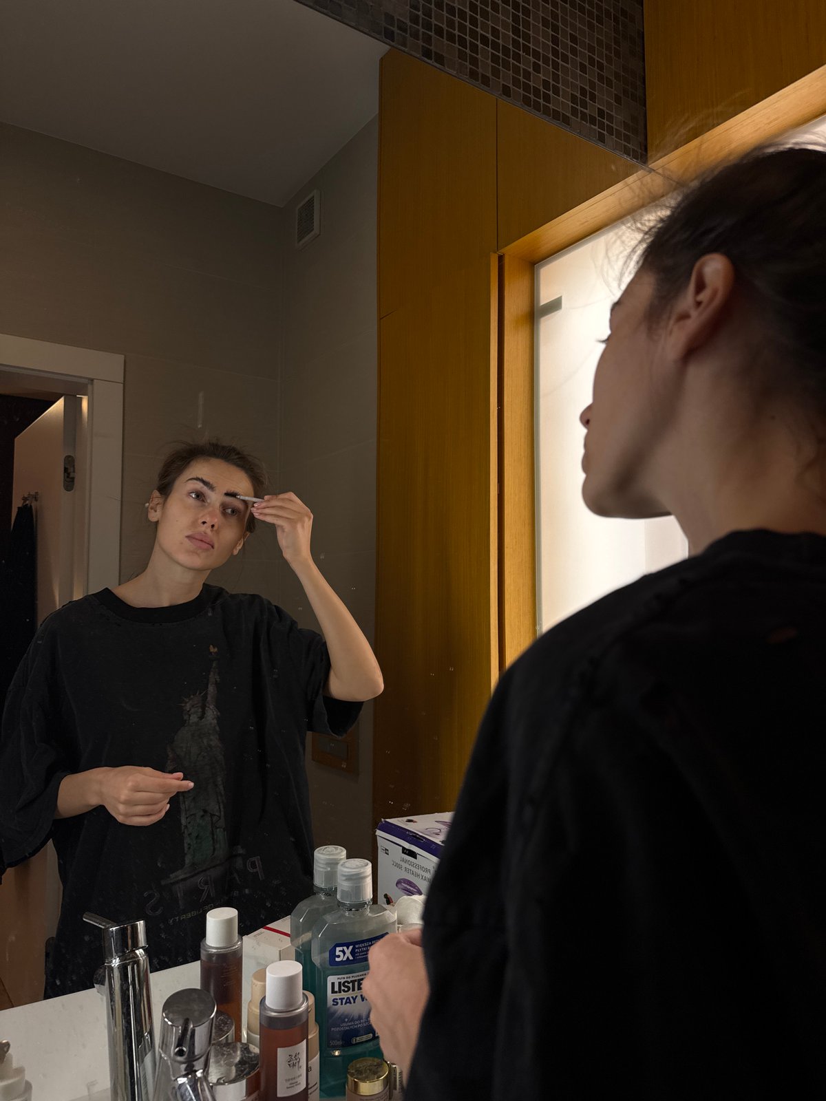 Woman conducts routine household activities in kitchen and bathroom