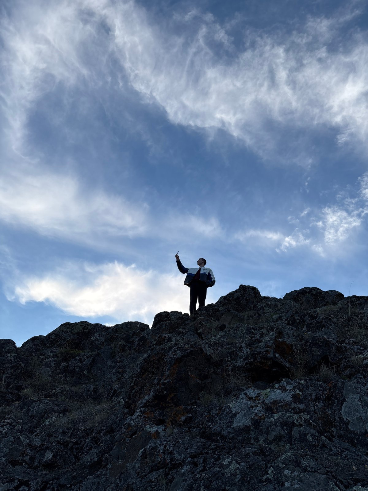 Person spends time contemplating at cliff edge near Невон