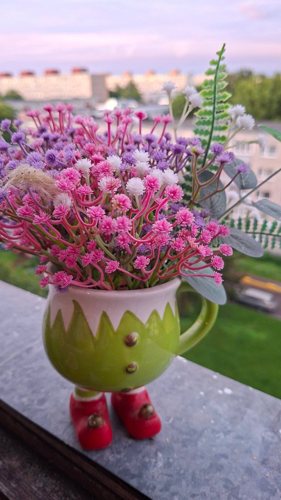 Tallinn evening: pastel skies, bokeh blooms, and a charming ceramic figurine