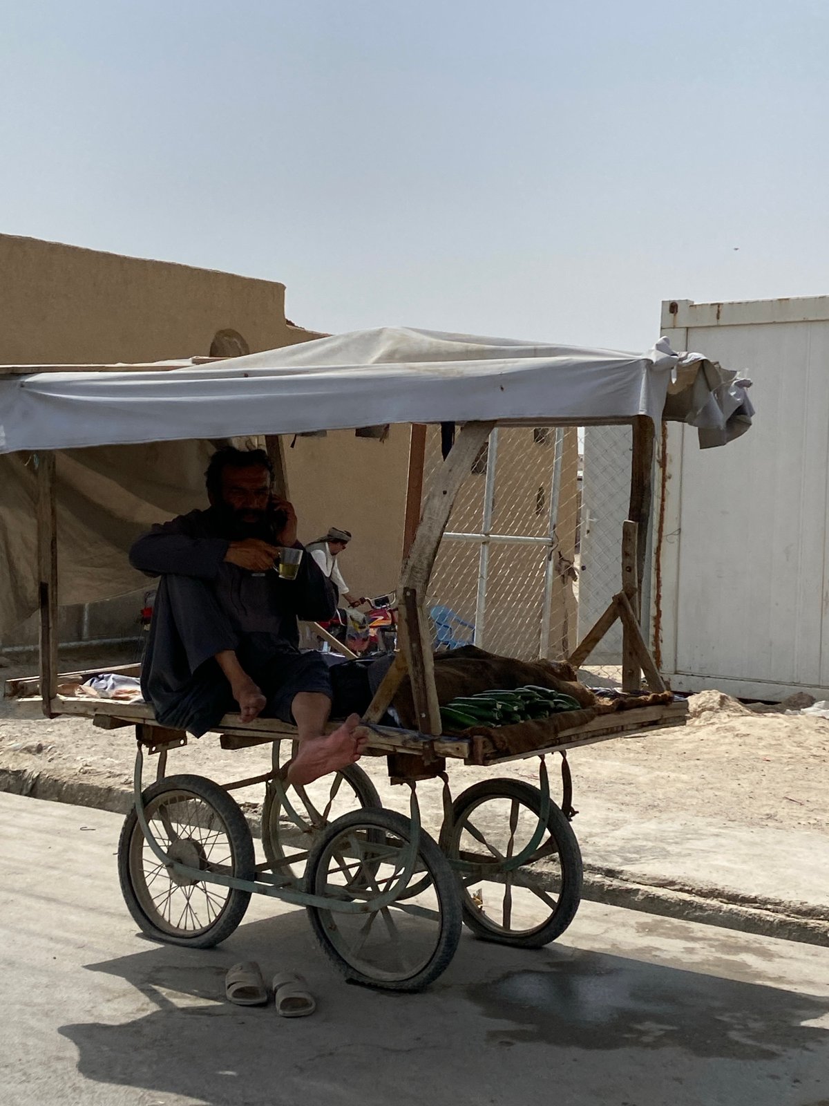 Kandahar street vendors and traffic on a July morning