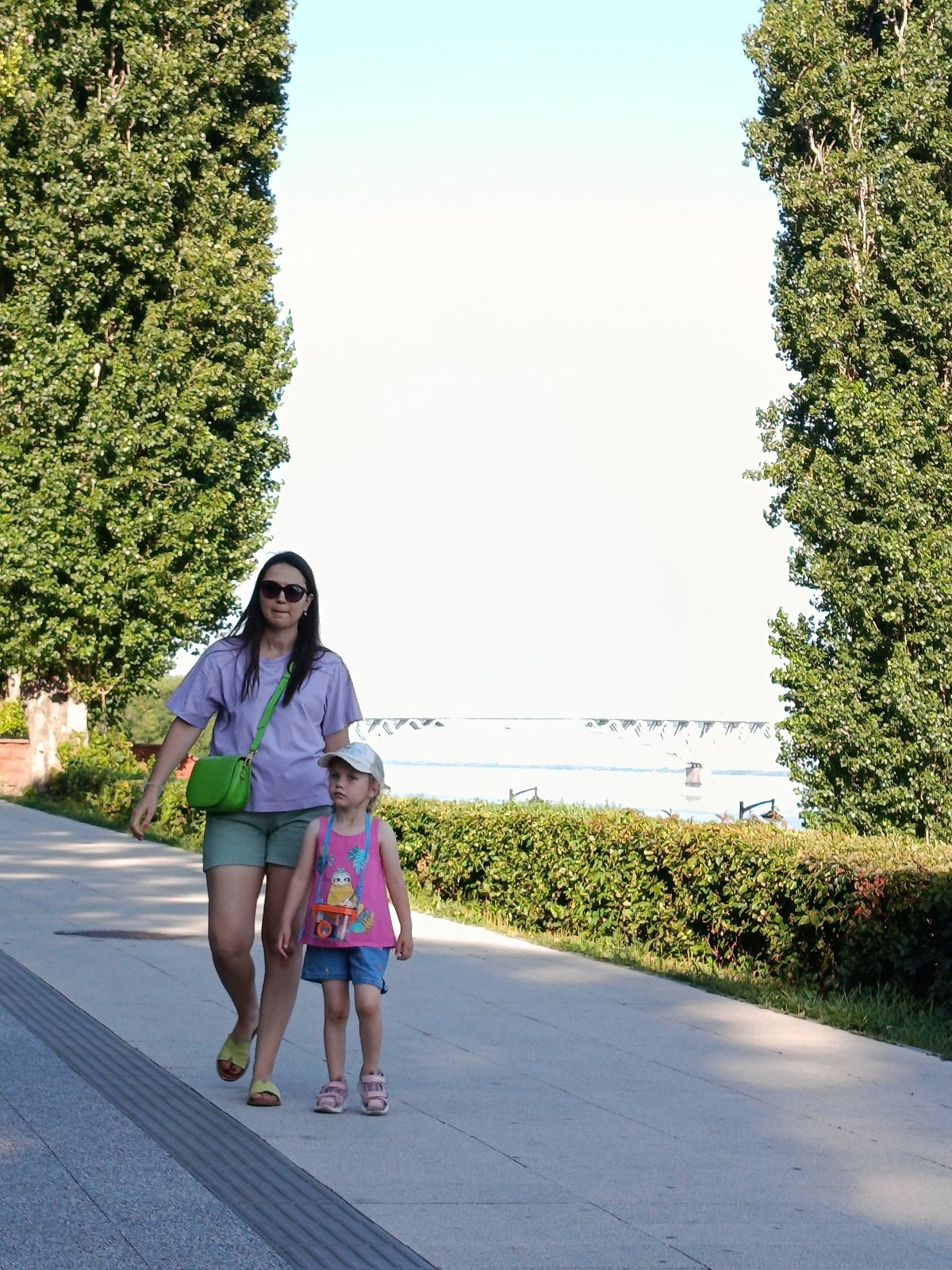 Sunny afternoon along a busy urban waterfront promenade