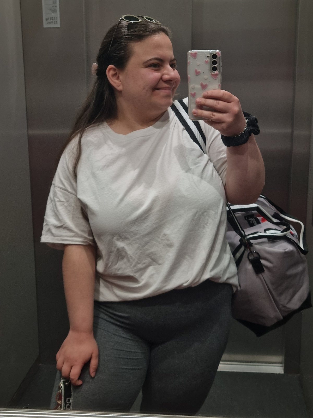 Woman takes elevator mirror selfie in Saarbrücken