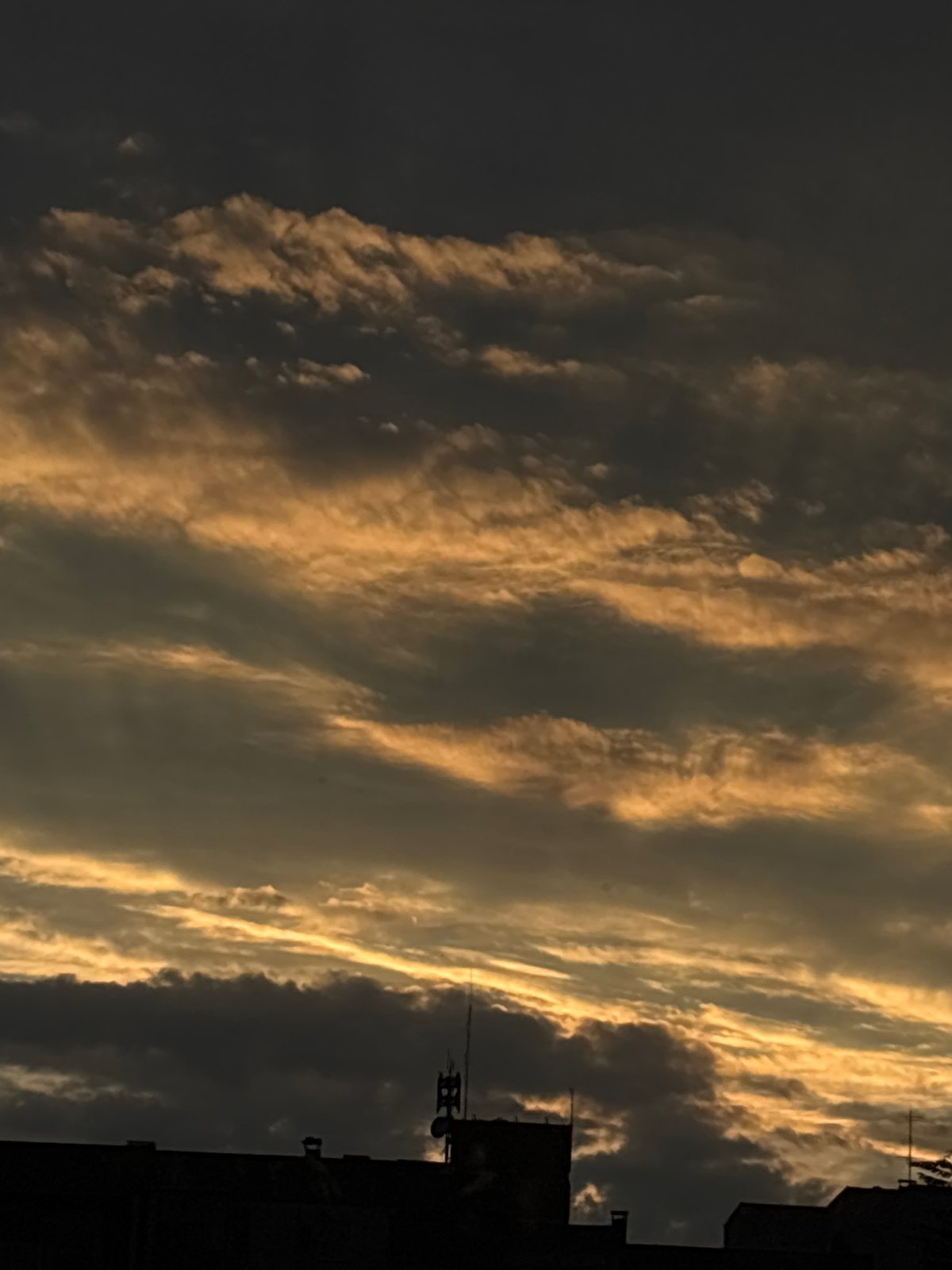 Golden sunset clouds shot from multiple angles in an urban setting.