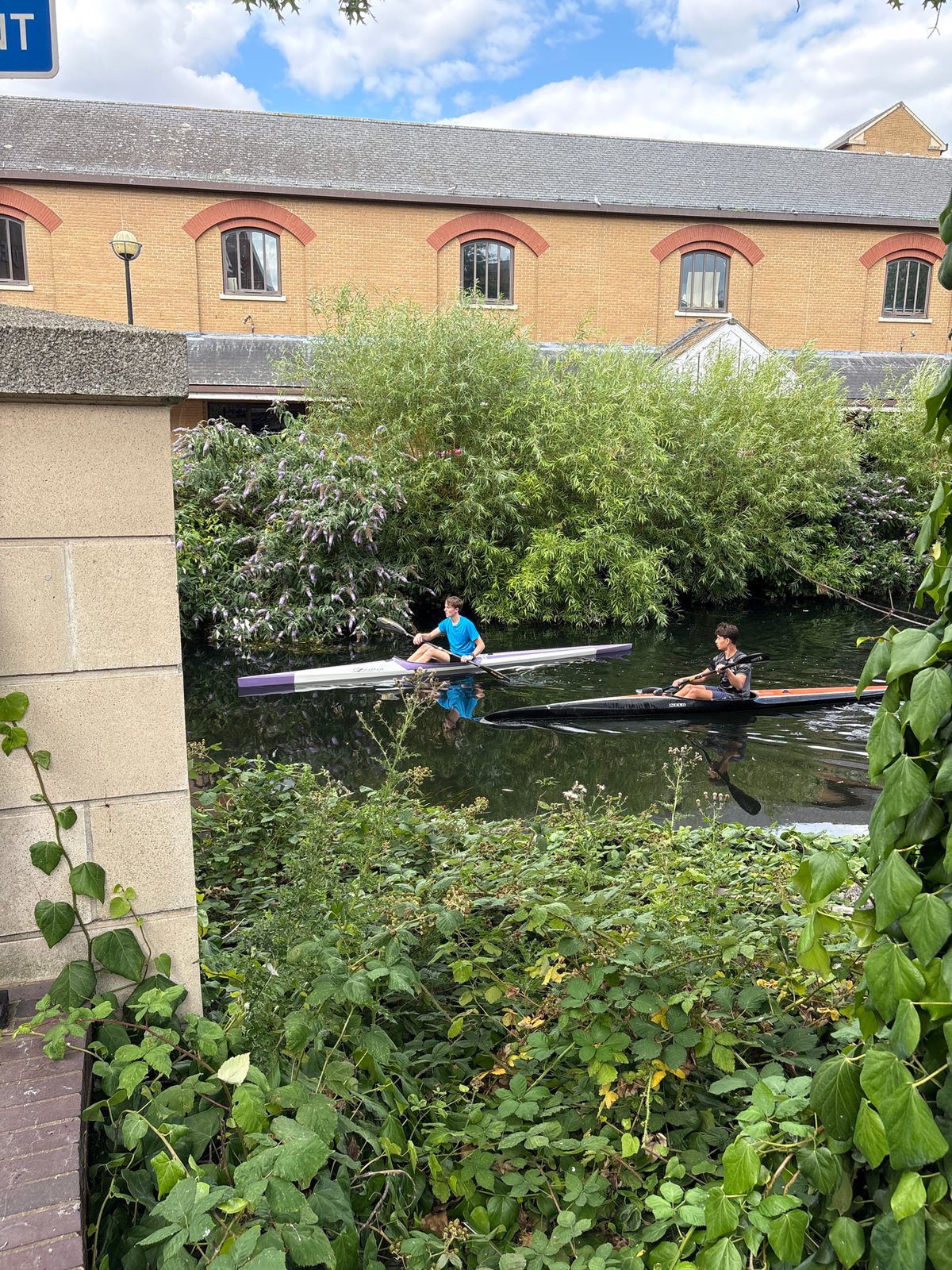 Kayaking a city canal with food and greenery along the way