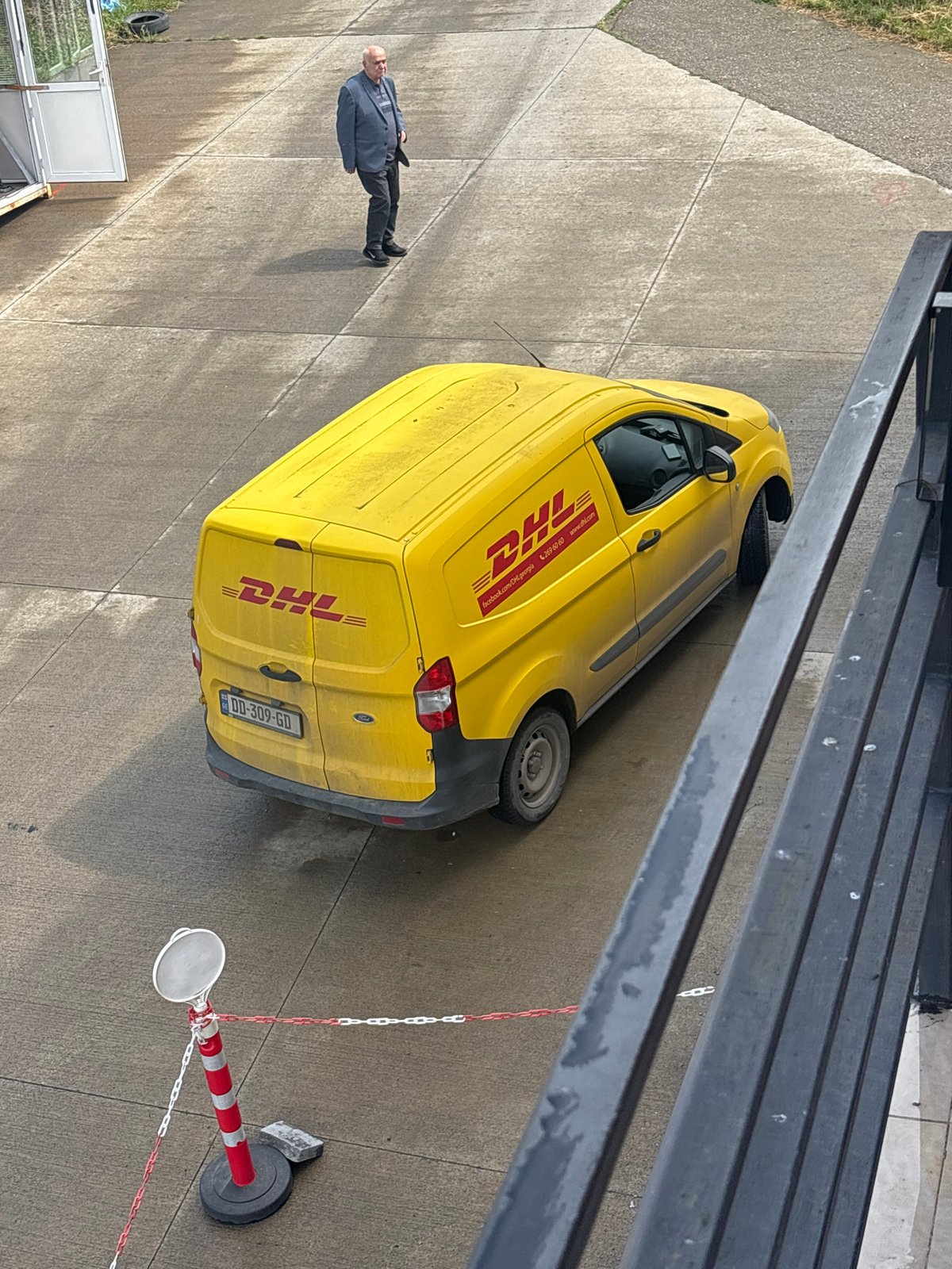 DHL delivery van departs Tbilisi parking area