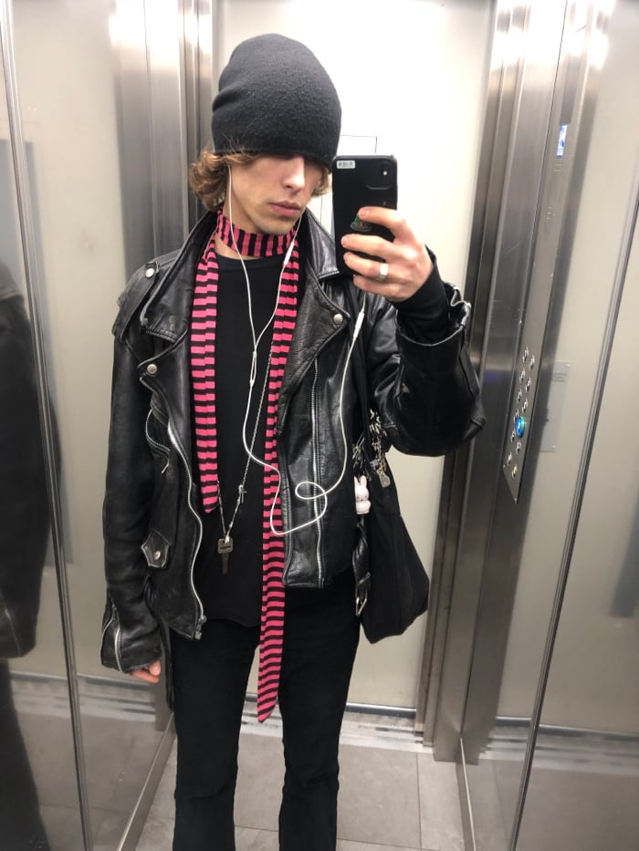 Person takes elevator selfie in Paris wearing black outfit