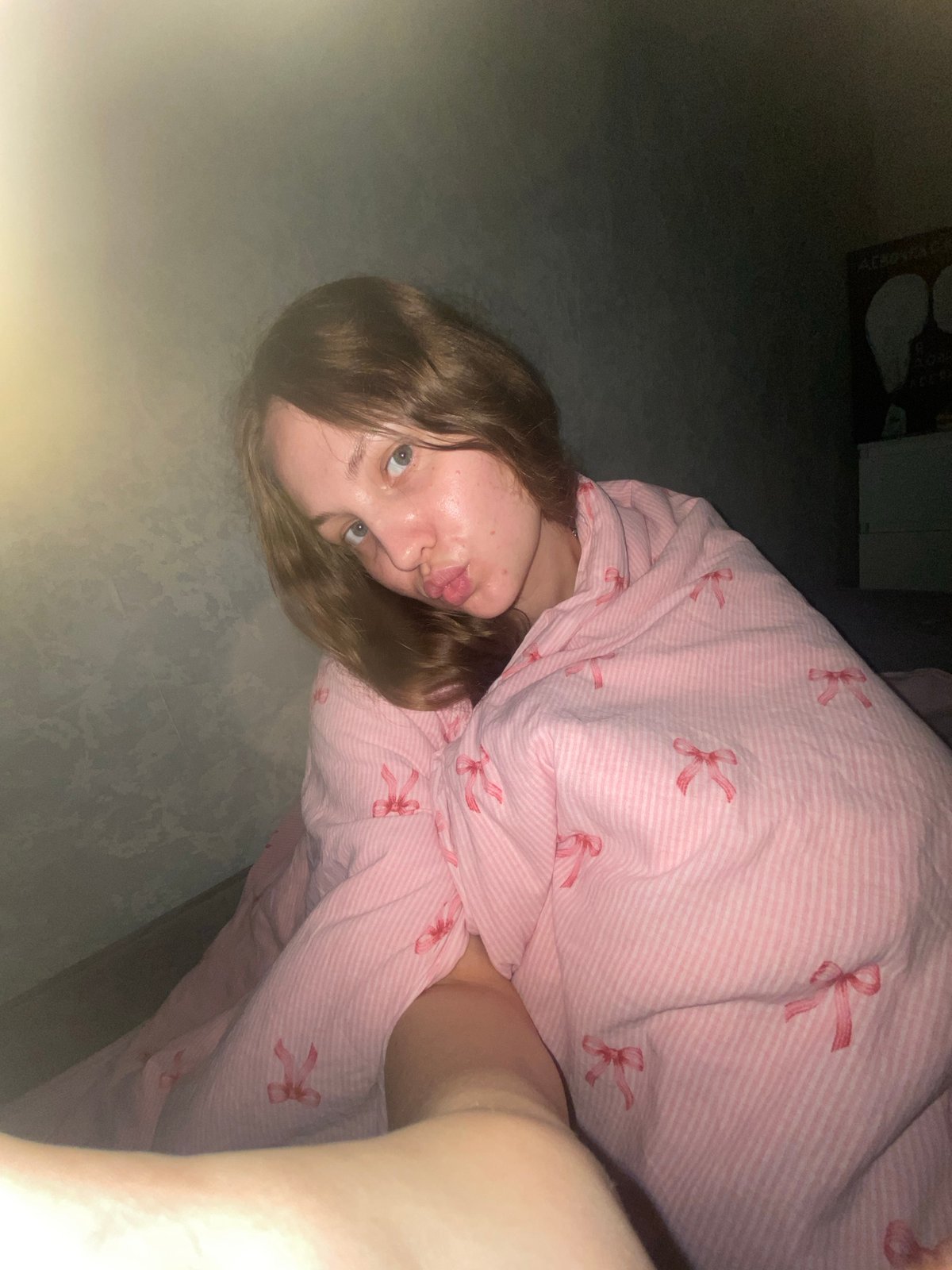 Cozy bedroom moment under a striped blanket in Izhevsk