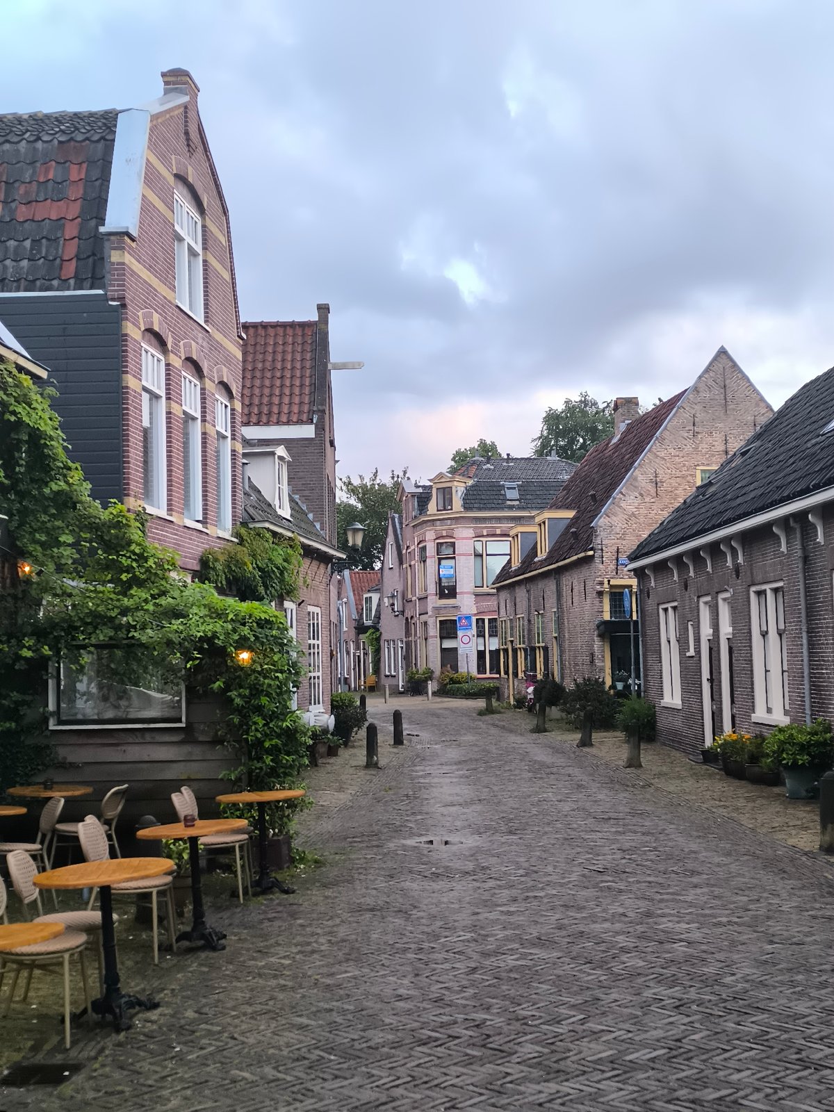 Evening stroll documented through rainy streets of Alkmaar, Netherlands